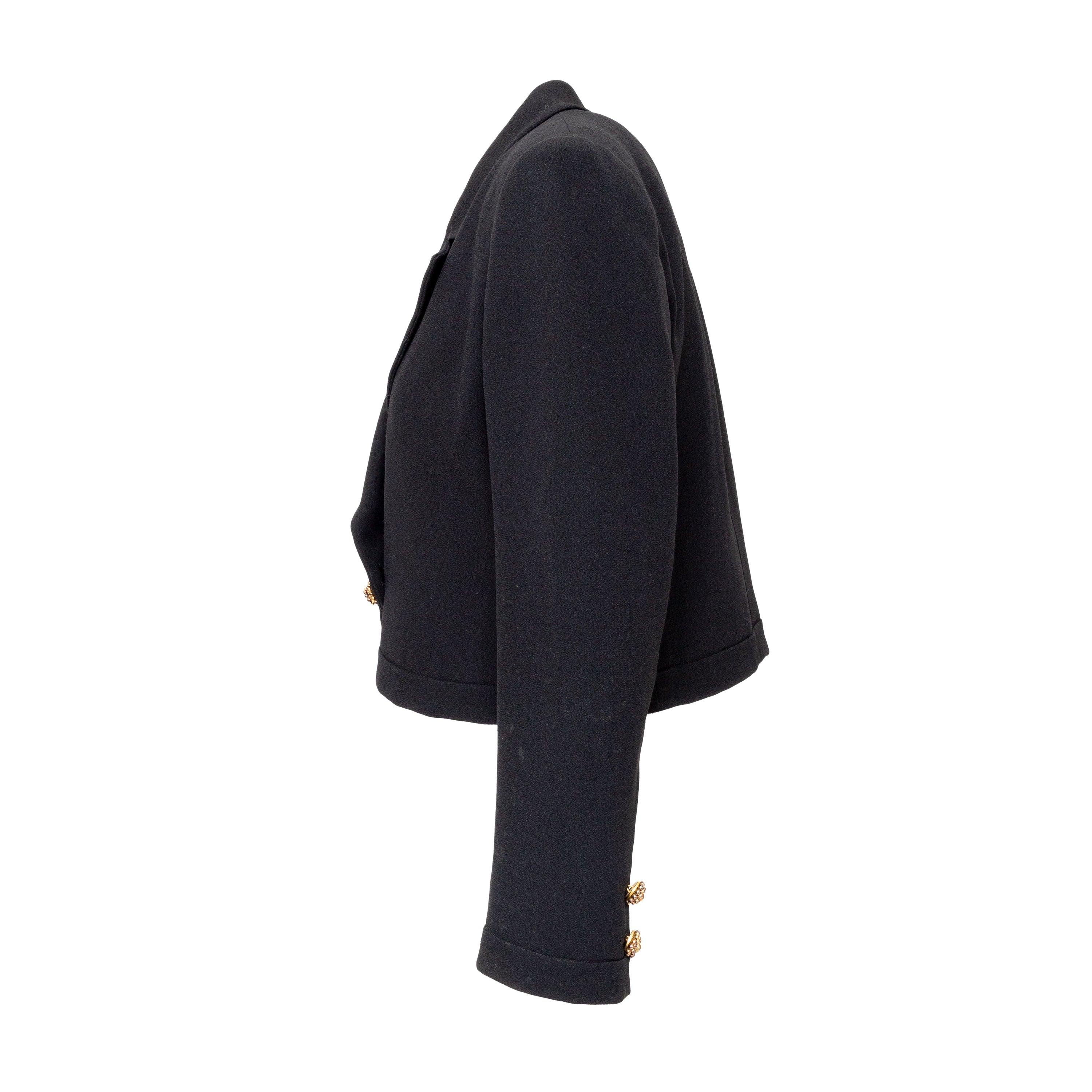 Add a touch of 80s glamour to your evening look with the Valentino Night Short Blazer. Crafted from a mixed fabric, this black blazer features a pleated design and a one-button closure for a sleek and stylish look. With a notched lapel collar and