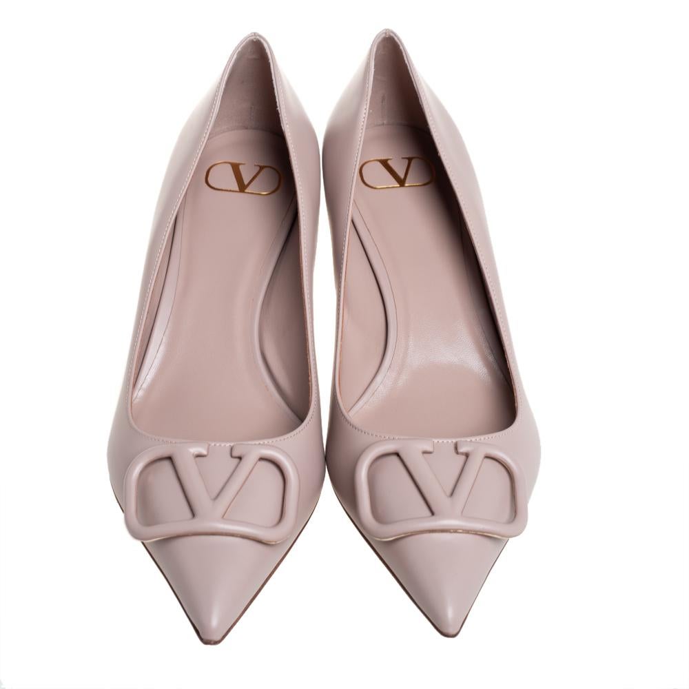 Valentino's pumps are rendered in nude-shaded leather and feature a sleek pointed-toe silhouette. The uppers are adorned with tonal VLogos for a signature touch, and they exude elegance. The kitten heels will go perfectly with midi dresses and