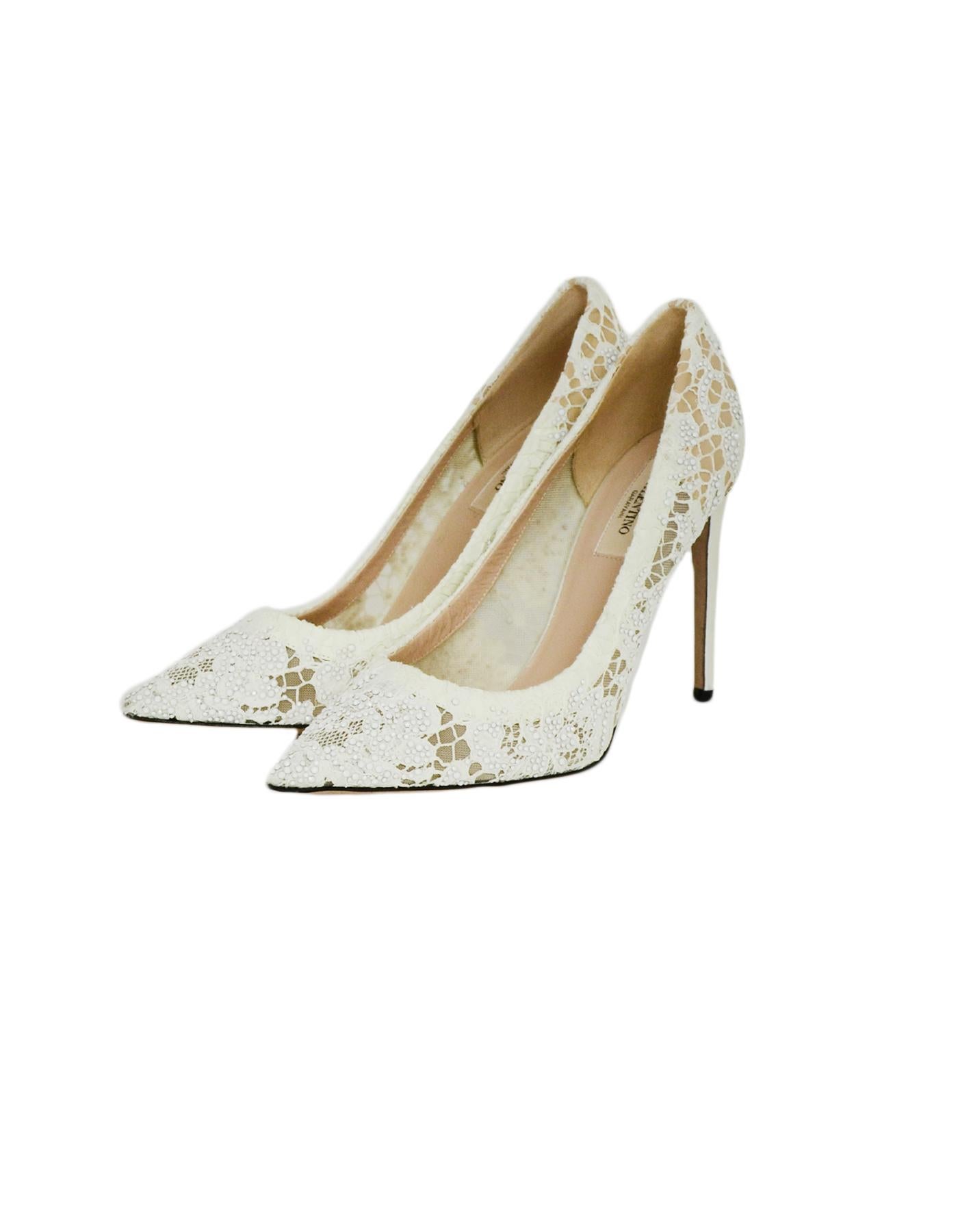 Valentino off-White Lace/Crystal Point Toe Pumps sz 39

Made In: Italy
Color: off-white
Materials: Lace, leather
Closure/Opening: Slide on
Overall Condition: Excellent pre-owned condition, very minor wear on soles and light marks to heels
Estimated