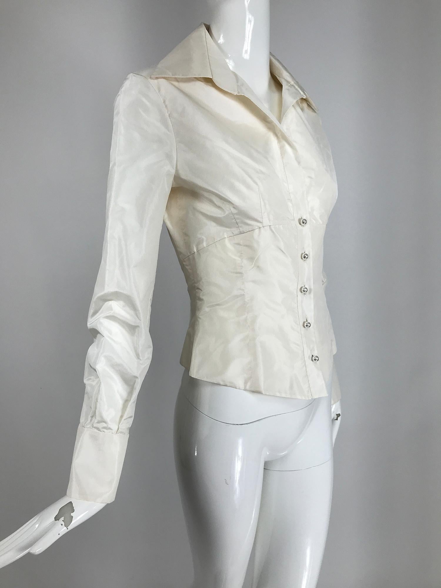 Valentino off white silk fitted blouse with long sleeves and wing collar. Darted bust and corset style waist. The back is cropped. Long sleeves have deep cuffs with button cuffs. Unlined. Marked size 6. 
     In excellent wearable condition.  All