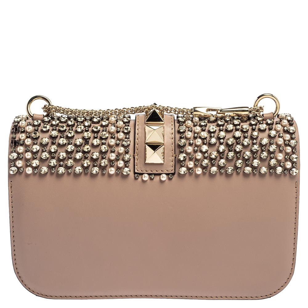 If you are looking for a bag with a blend of modern style and class, this Valentino creation is the answer. Crafted from leather and embellished with crystals and beads, this piece comes with a gold-tone chain and a flap with a push-lock to secure