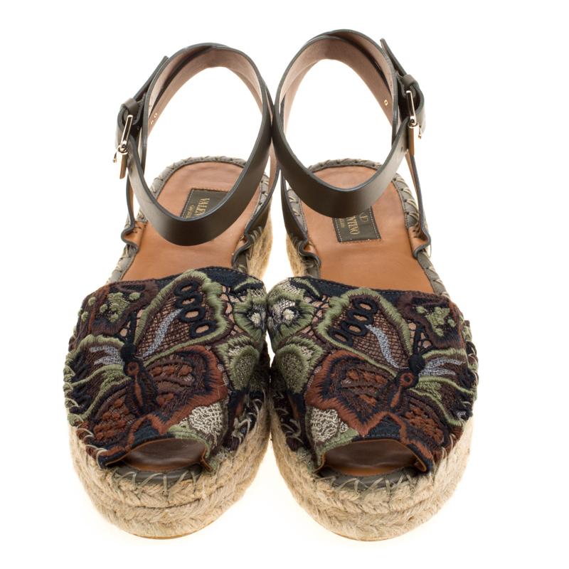 Step out in style with these trendy espadrilles from Valentino. Featuring a pretty embroidered exterior, this round-toe pair is completed with braided jute details on the midsole and leather ankle straps.

Includes: Original Box, Original Dustbag,