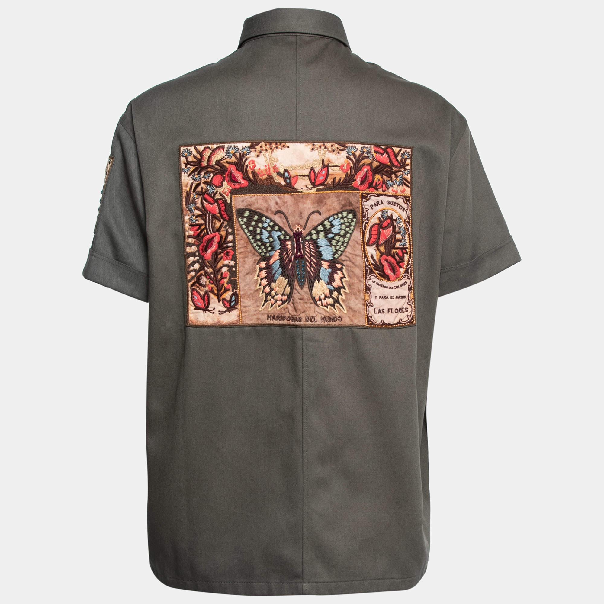 Redefine your casual style with this shirt from the House of Valentino. It is tailored using olive-green cotton fabric, which is highlighted with multicolored patch appliques. It features short sleeves, a button-front style, and four frontal