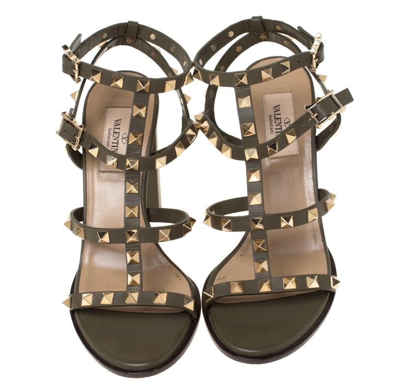 Adorned with signature Rockstuds, this pair of sandals by Valentino are elegantly designed to exude an aura of sophisticated style. Crafted into a chic cage silhouette and fitted with block heels, these shoes can perfectly match your party ensemble