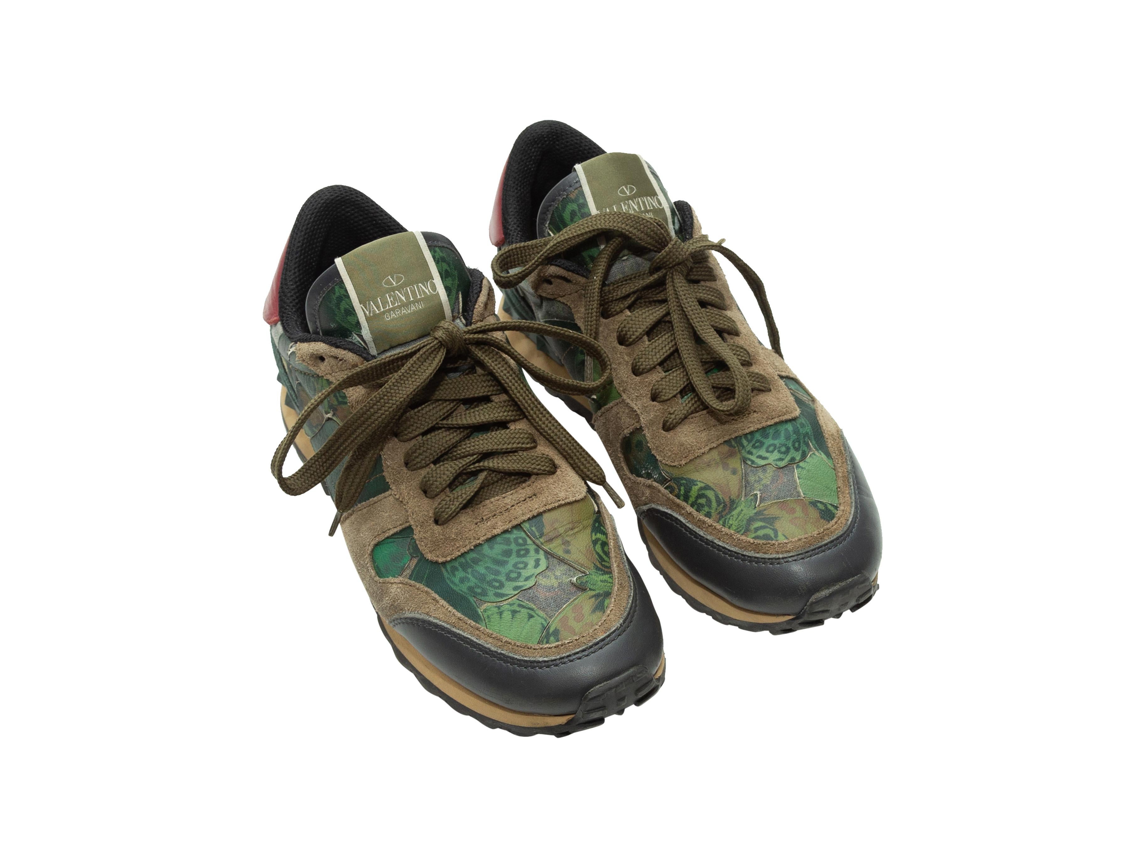 Product details: Olive green suede and multicolor Camubutterfly low-top sneakers by Valentino. Red leather trim at backs. Rockstud trim at heels. Lace-up tie closures at tops. 1