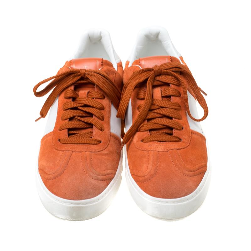These Flycrew sneakers from the house of Valentino have been designed in a suede and leather body. It comes with lace-ups and is set on a subtly raised sole. It is detailed with the signature pyramid studs from the house. Style your with weekend