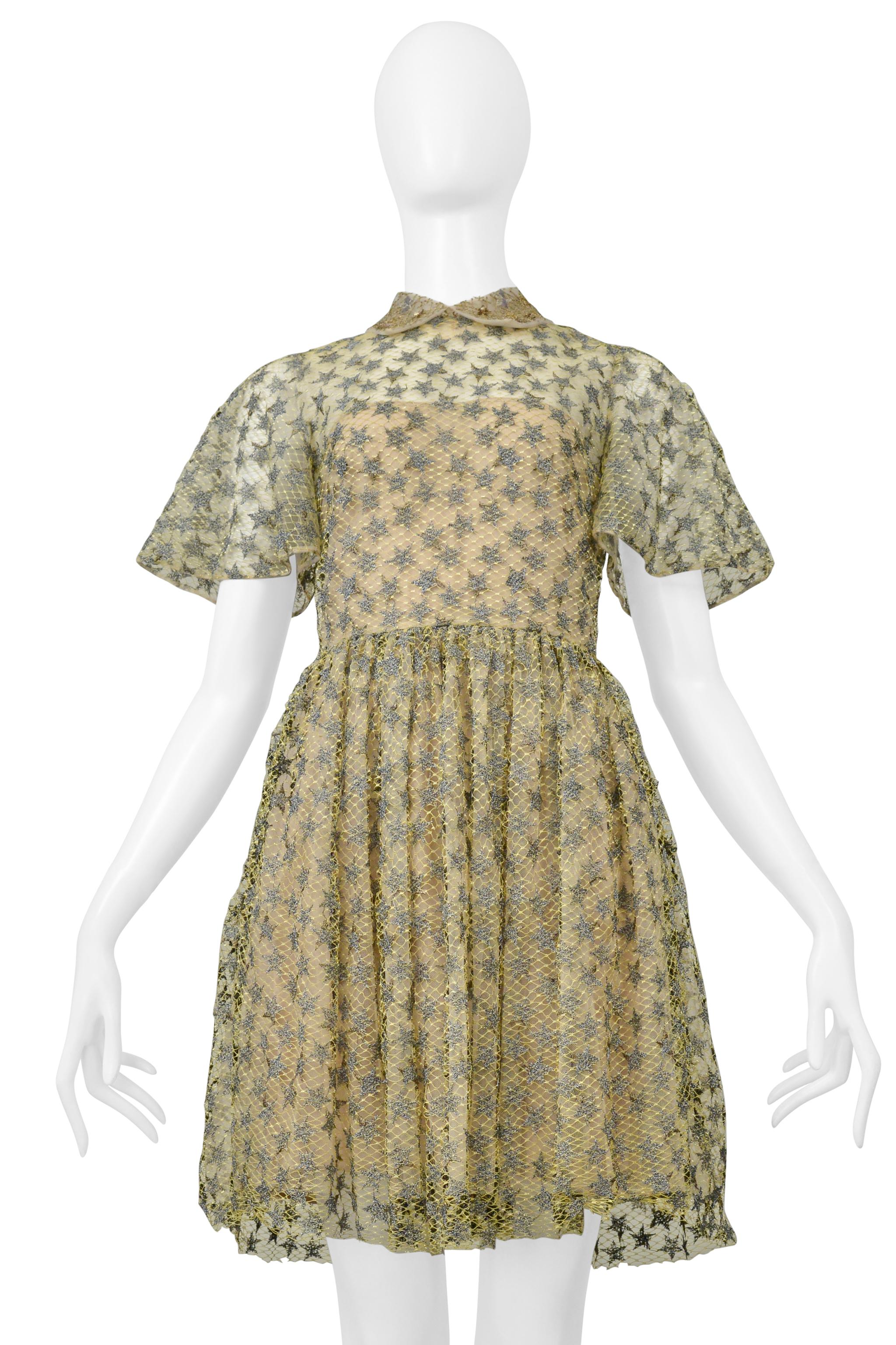 Resurrection Vintage is thrilled to present a muted yellow Valentino party lace dress adorned with silver stars. It features a folding collar with sequins, a fitted bodice with delicately belled sleeves, a gathered skirt, a center-back zipper, and
