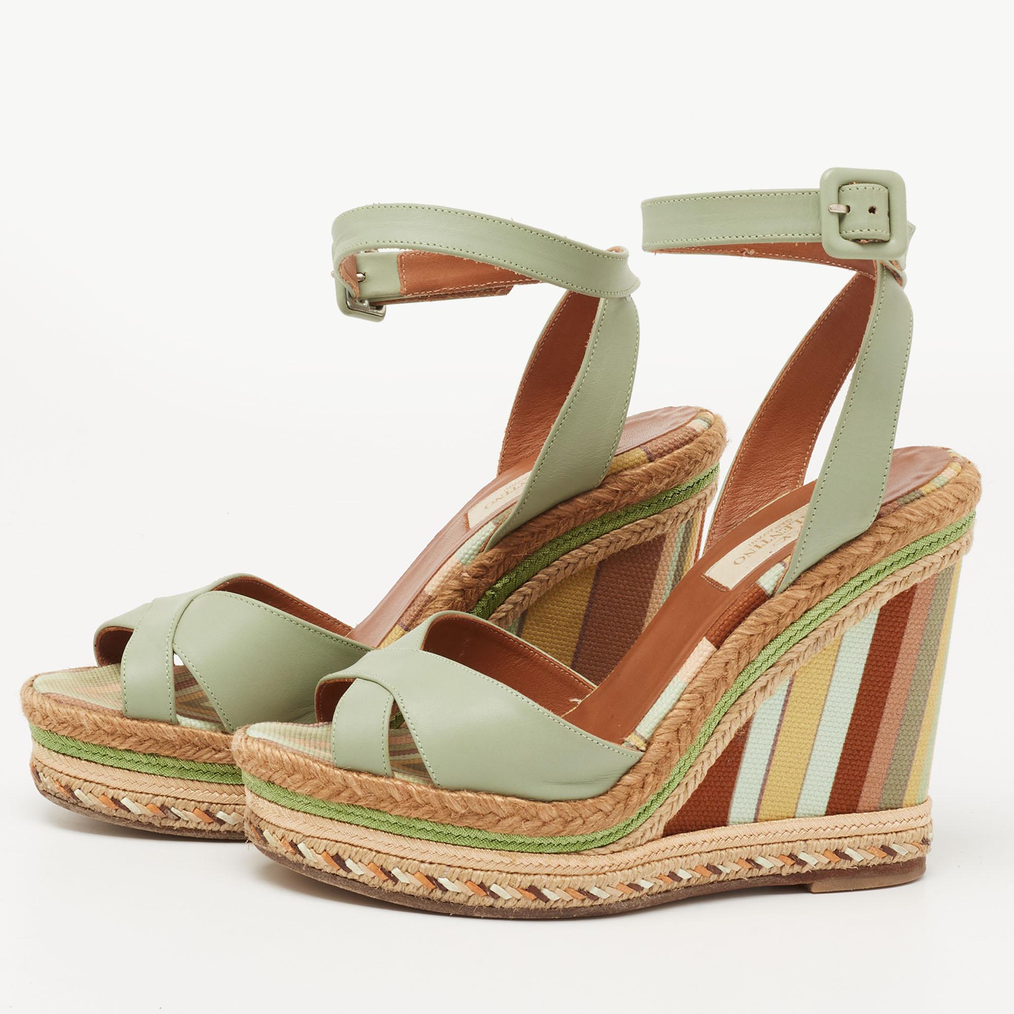 These sandals from the House of Valentino are all about flaunting eternal class and elegance! They are made from pastel green leather on the exterior and feature open toes, espadrille wedge heels, and an ankle strap feature. Flaunt your chic style