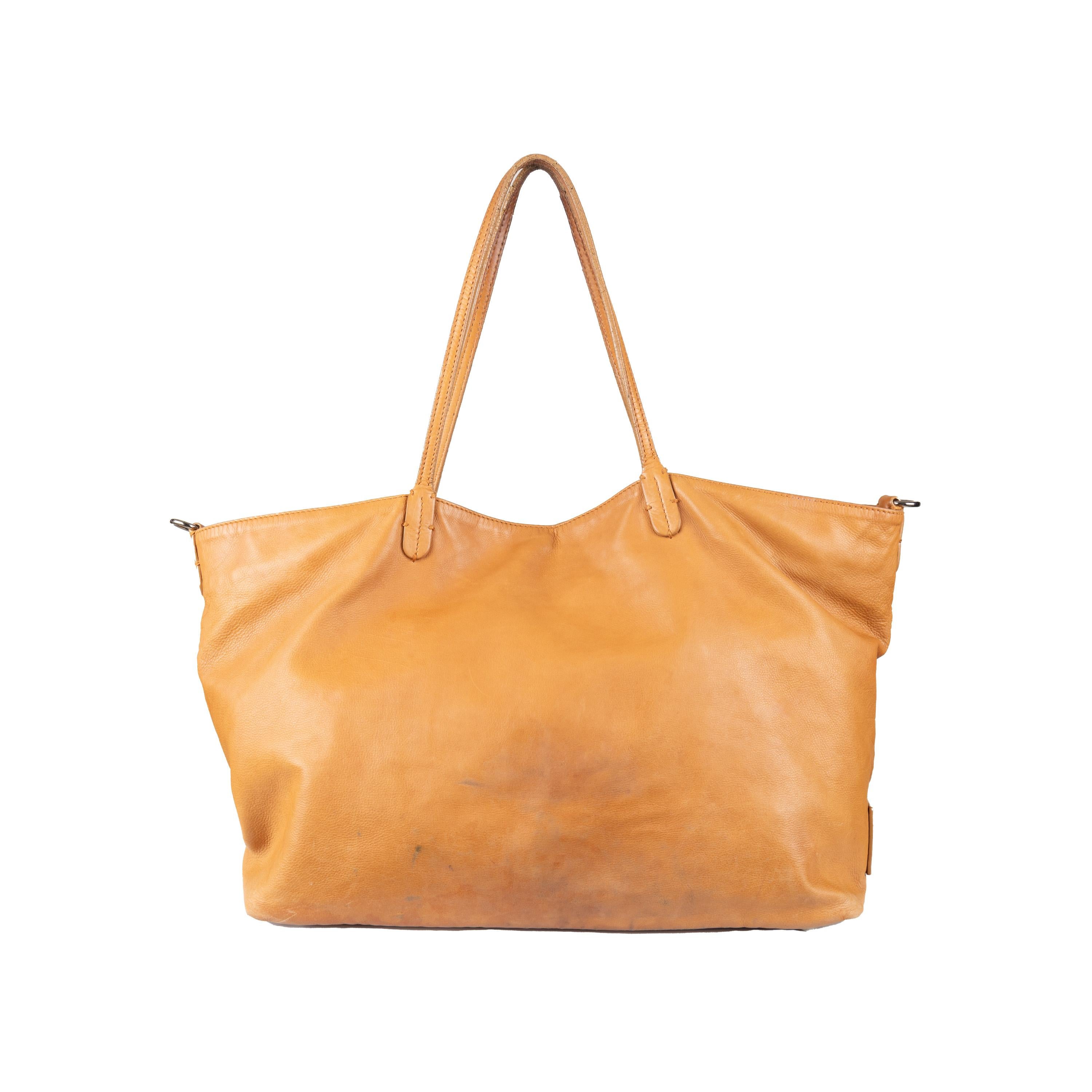 Elevate everyday style with the Valentino Petale Tote Bag. Crafted from luscious tan brown leather, this chic tote features a delicate petal design on the front and two top handles. With a large storage compartment and magnetic snap closure, this