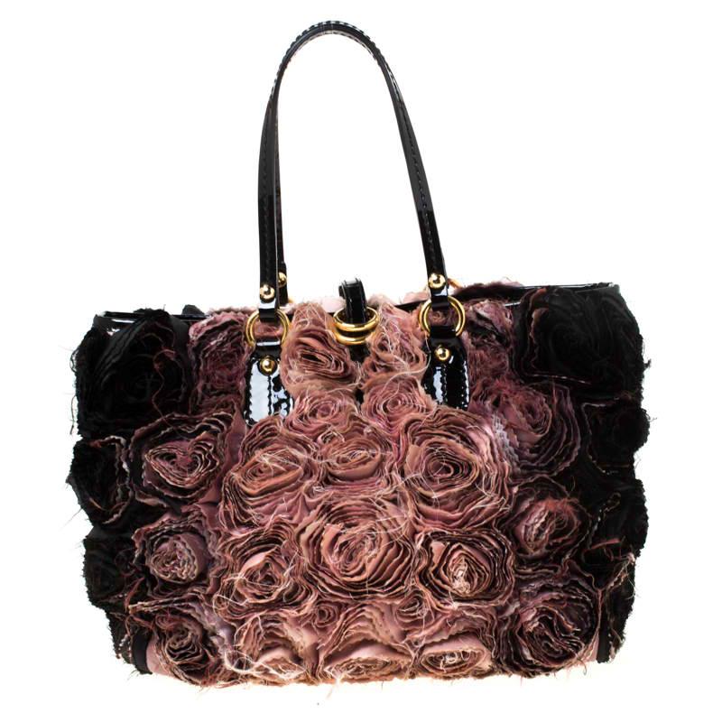 Set in a contemporary design and style, this tote from Valentino is absolutely mesmerizing. The lovely Organza Rosier tote features beautiful silk organza appliques all over. It comes with leather top handles, a spacious satin-lined interior to