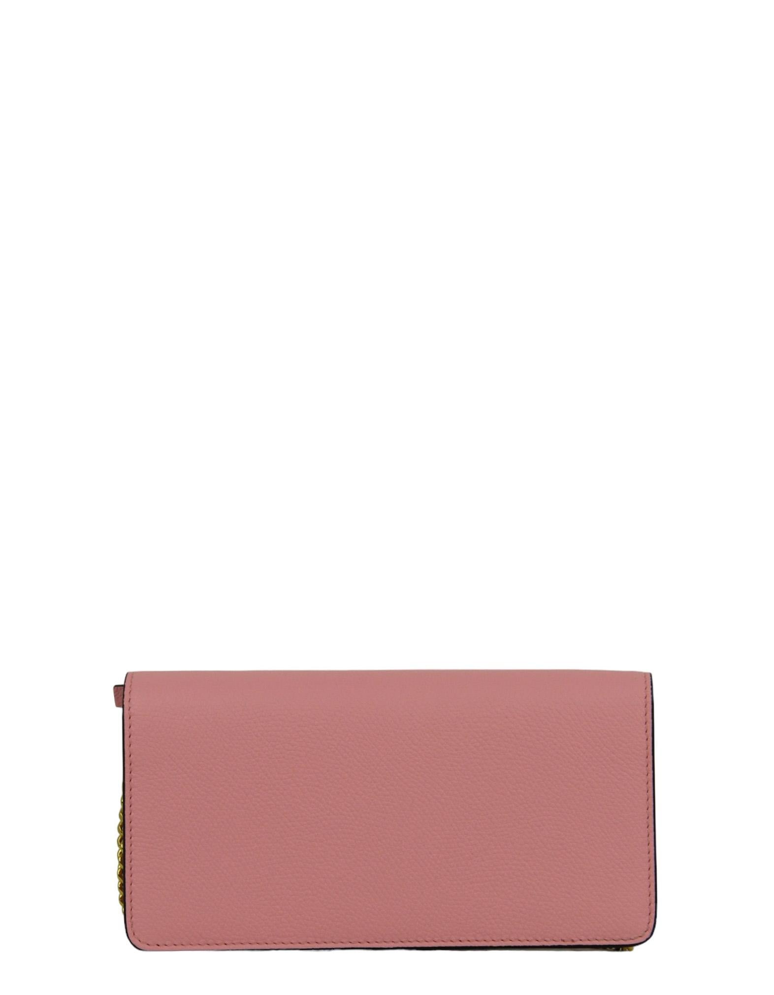 Valentino Pink Grainy Calfskin Leather V Logo Wallet on a Chain Crossbody Bag/ Clutch

Made In: Italy
Color: Pink
Hardware: Pale goldtone
Materials: Grained calf leather
Lining: Leather and textile
Closure/Opening: Top flap with magnet
Exterior