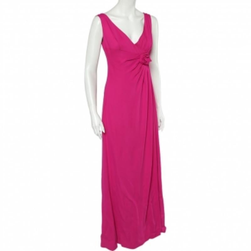 Appear radiant and glamorous as you don this beautiful gown from the House of Valentino! It has been luxuriously designed using pink crepe fabric, with draped formations elevating its appearance. It displays a V-neck and slit detail. This gown has a