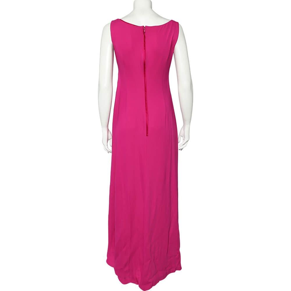 Appear radiant and glamorous as you don this beautiful gown from the House of Valentino! It has been luxuriously designed using pink crepe fabric, with draped formations elevating its appearance. It displays a V-neck and slit detail. This gown has a