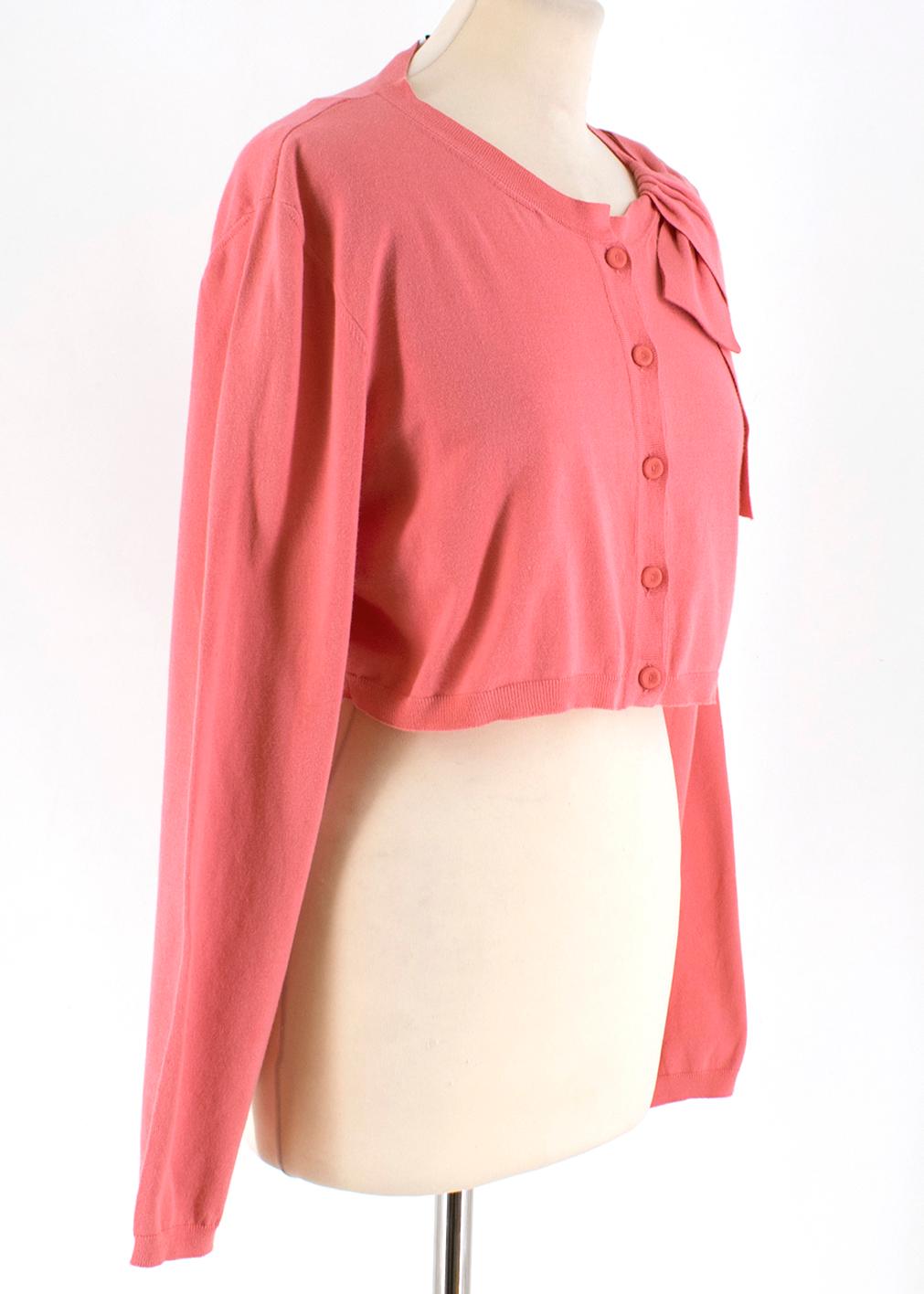 Valentino Pink Bolero  

- Cotton pink bolero with a bow detail on the neck
- Lightweight, soft touched 
- Scoop neck 
- Button fastening at the front

Please note, these items are pre-owned and may show some signs of storage, even when unworn and