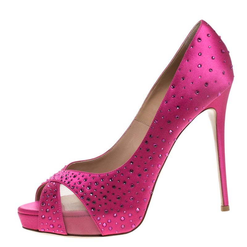 You can’t stop yourself from falling in love with these platform pumps from Valentino. Crafted from pink satin and embellished with crystals, they feature peep toes and 13 cm high heels supported by platforms.


