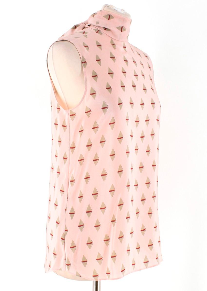 Valentino Pink Geometric Silk Neck Tie Blouse

-Pink blouse with geometric print
-Features neck tie which can be worn multiple ways
-Key hole cut out with button closure
-Sleeveless top

Please note, these items are pre-owned and may show signs of