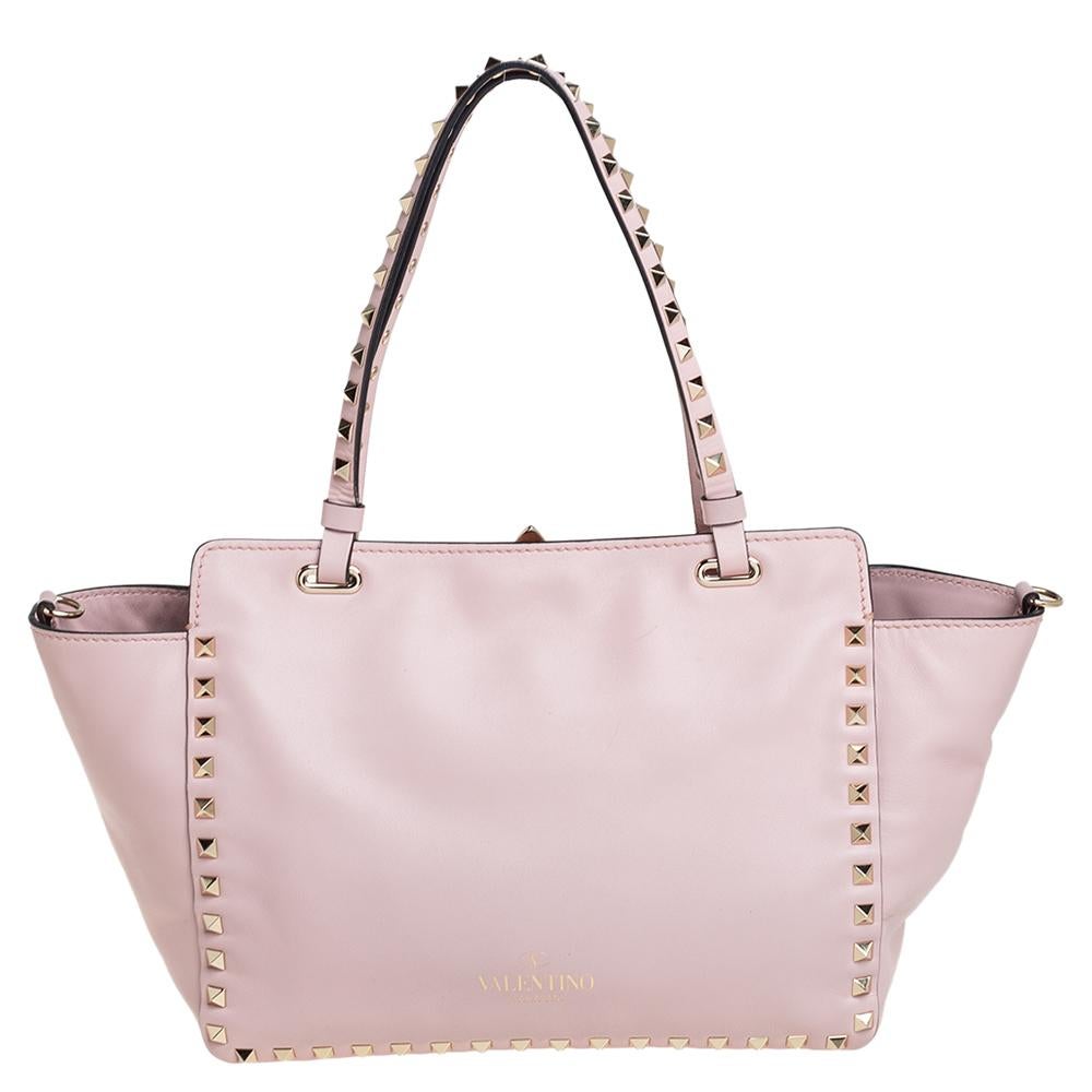 Luxury Italian fashion house Valentino is famed for its classic designs infused with its own signature modern edge and Rockstud details as showcased by this trapeze tote. Crafted from leather, it features top handles and a detachable shoulder strap