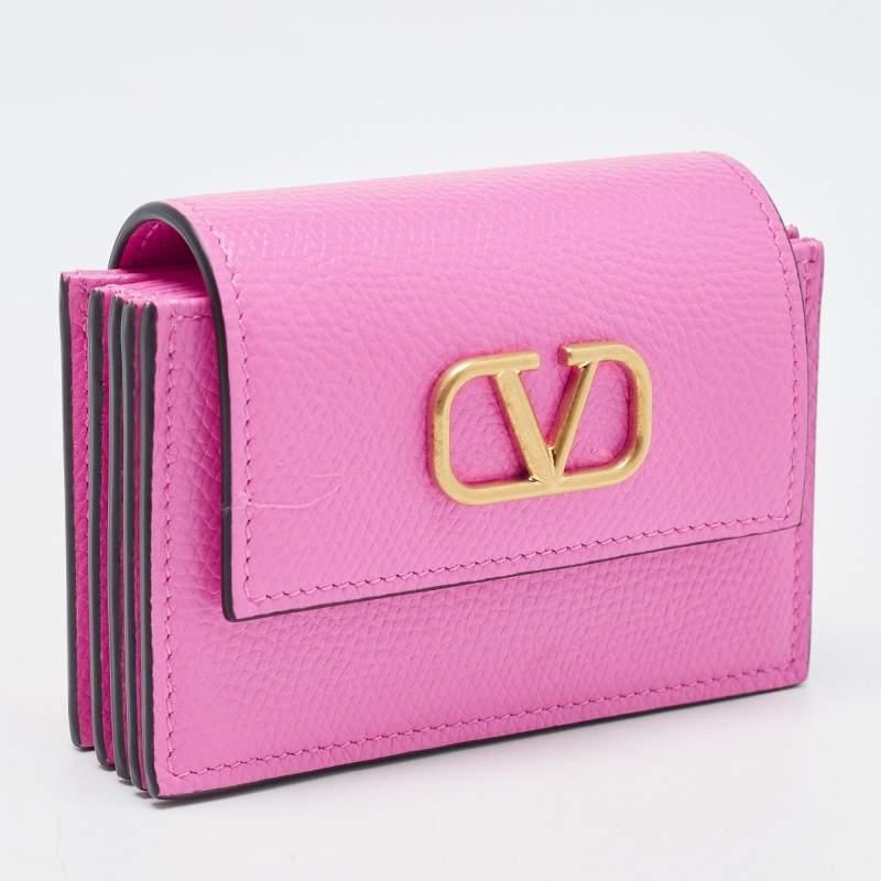 The Valentino card case arrives in a pretty pink hue with the notable VLogo in gold-tone metal on the front. This compact accessory is perfect for organizing and carrying your everyday cards with a touch of elegance.

