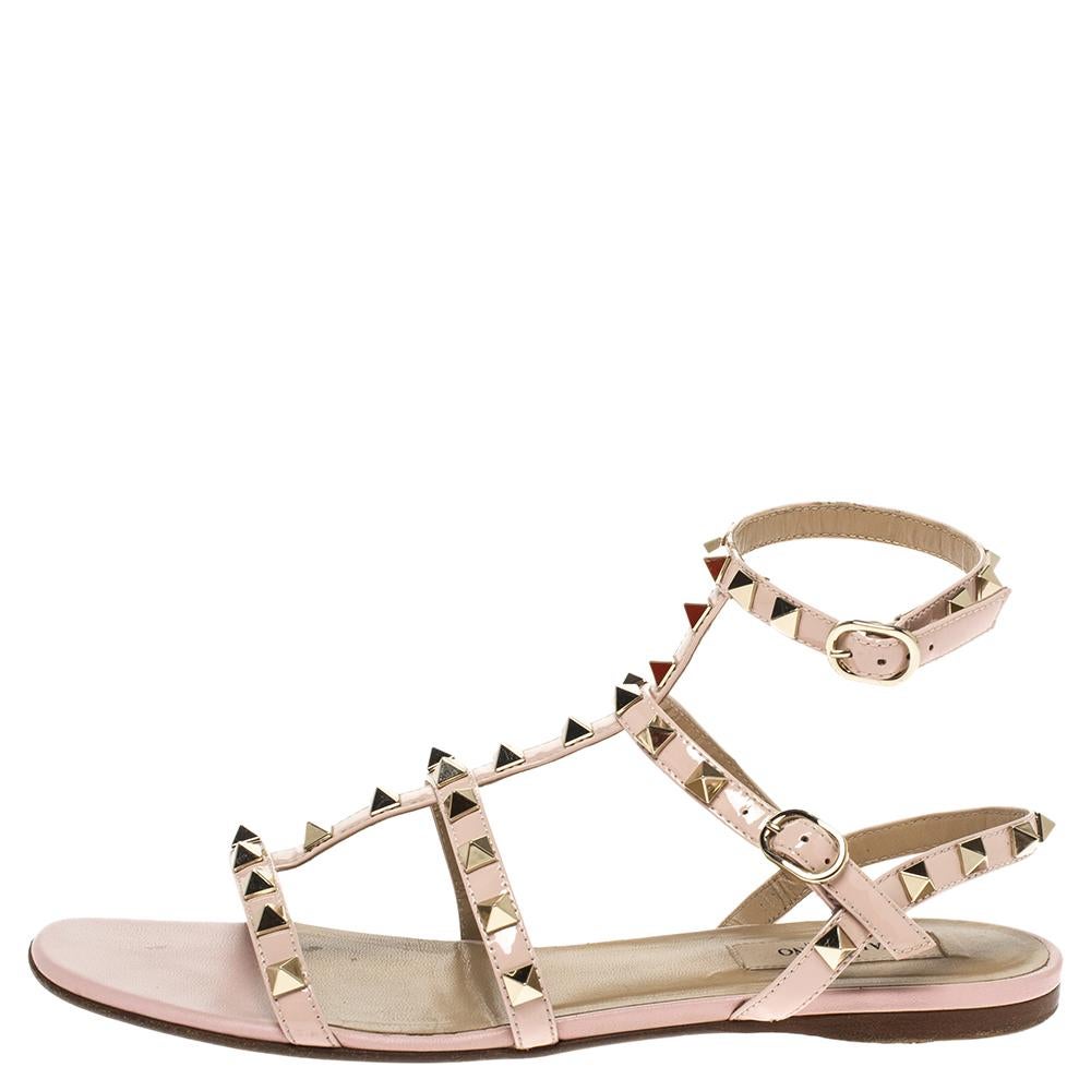 These sophisticated Cage sandals by Valentino are must-haves. Crafted from leather, they come in a soft pink hue and Rockstud detailing on the straps. They feature open toes and dual buckle fastenings.

Includes: Info Booklet, Original Dustbag,
