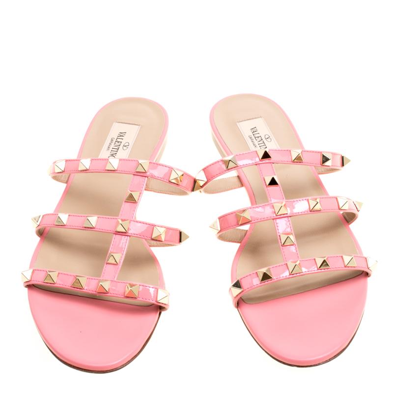 Fall in love with these cage flats by Valentino! They have been beautifully crafted from leather and styled with the signature Rockstuds on the straps. The pink colored flats will bring you countless days of style.

Includes: Original Box, Original