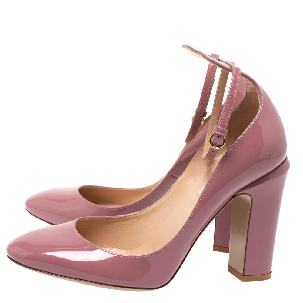 Steal the show with these pink pumps from Valentino. Designed in a patent leather body, this pair is set on a comfortable block heel and comes with an ankle strap closure. It features an almond-shaped toe and comes with a branded leather-lined