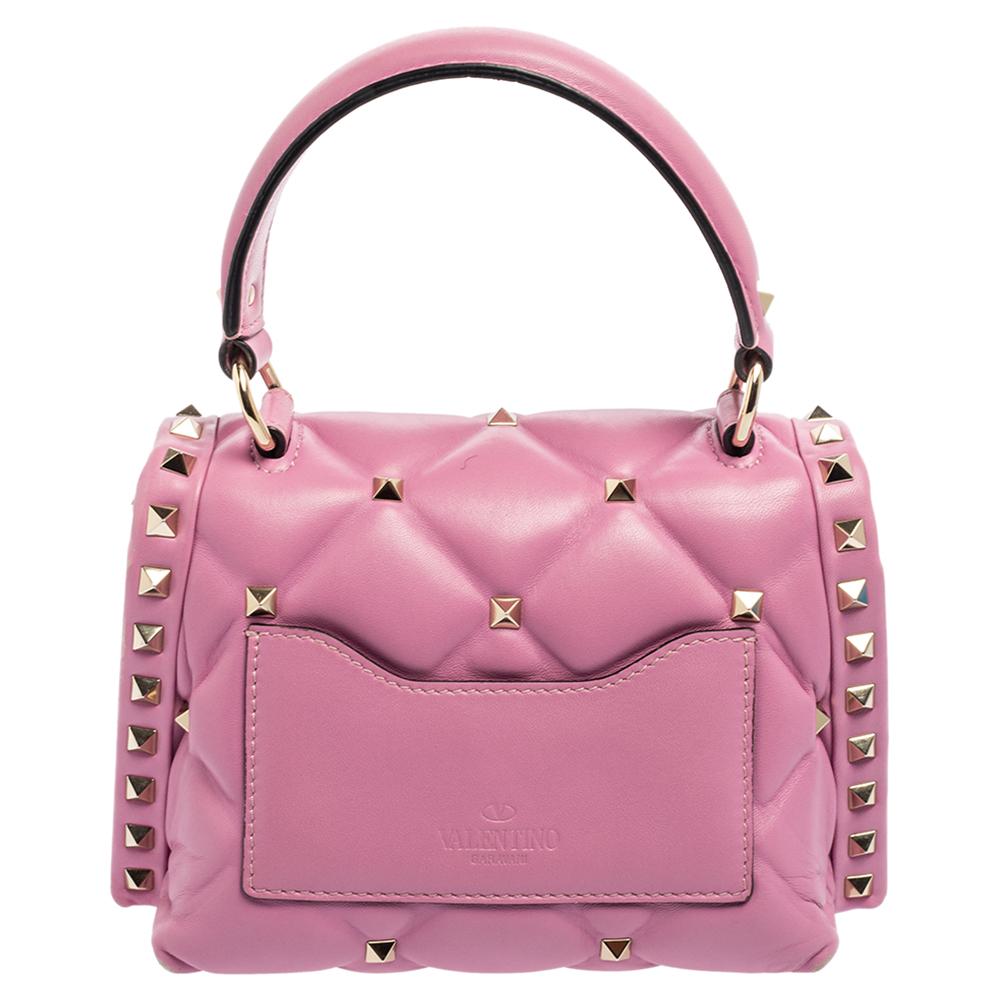 Valentino's Candystud is full of beauty, signature elements, and wondrous details. It is crafted from leather and punctuated with studs on the quilted surface. It is complete with a top handle and shoulder strap.

Includes: Original Dustbag,