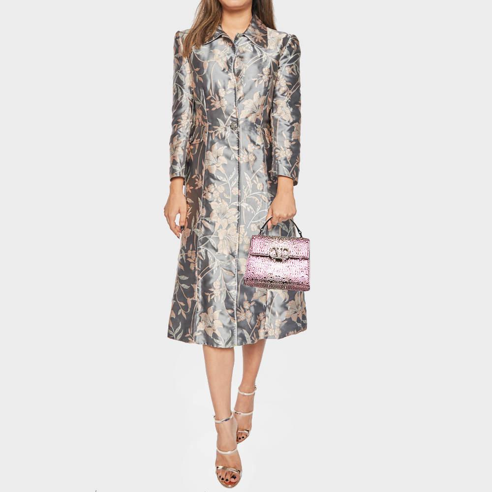 The Valentino VSling Top Handle Bag features a luxurious pink suede exterior adorned with sparkling crystals  creating a sophisticated look. This compact yet chic bag includes a signature VLogo closure  a top handle  and an adjustable shoulder strap