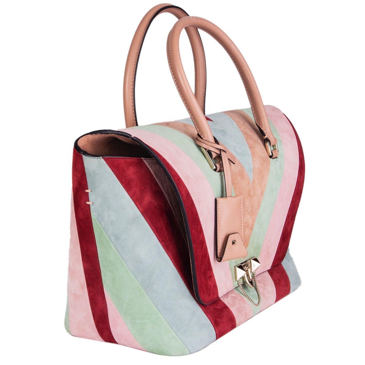 Valentino 'Demilune Medium Chevron' tote in burgundy, nude, pink, sage and light blue suede with nude leather details. Adjustable and detachable shoulder strap. Open pocket on the outside back. Closes with a flip-lock on the front. Lined in nude
