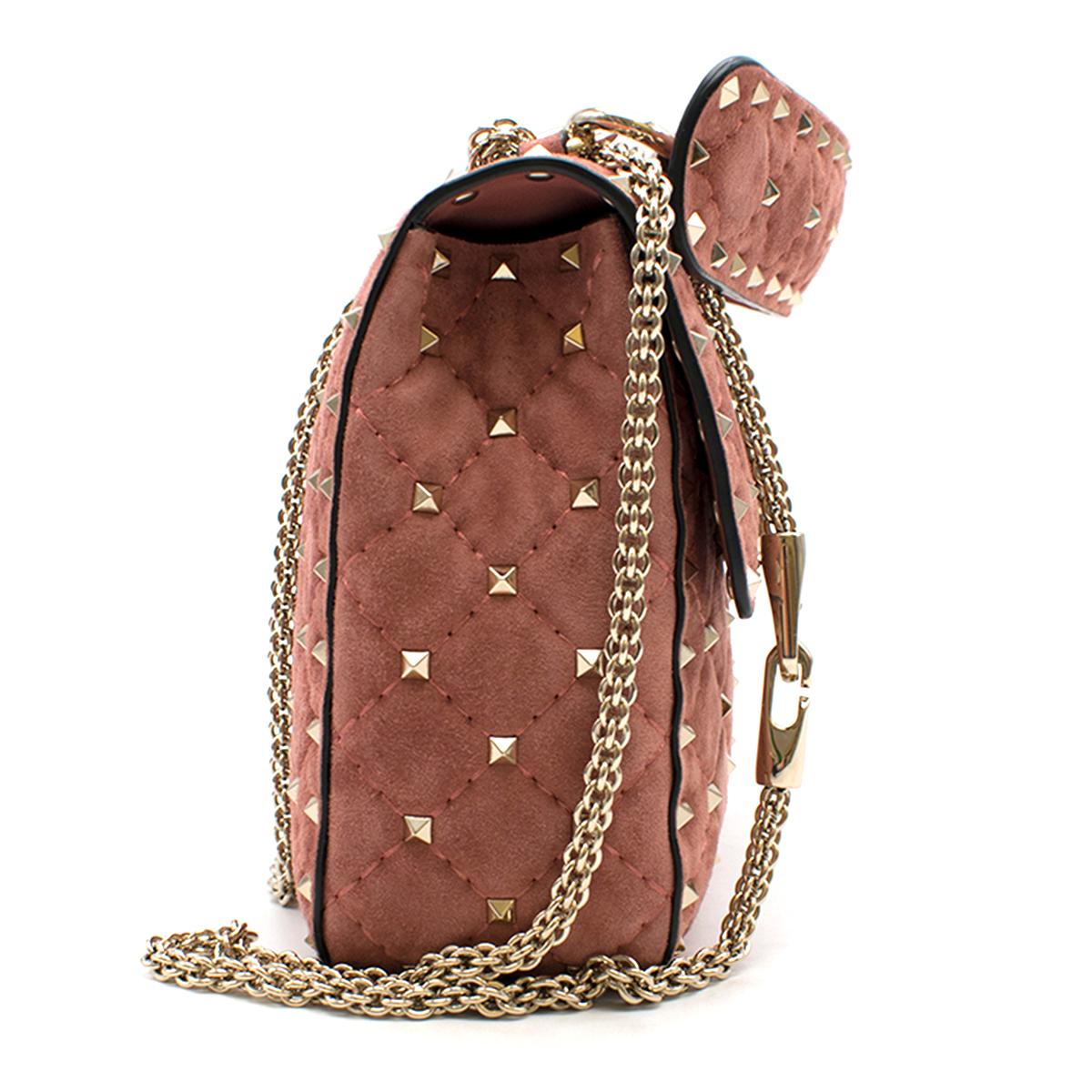 Valentino Pink Suede Rockstud Spike Medium Chain Bag

- Valentino Garavani Rockstud Spike medium chain bag in rose pink suede. 
- Micro stud detailing.
- Thanks to the detachable top handle and the sliding and detachable chain strap, the bag can be