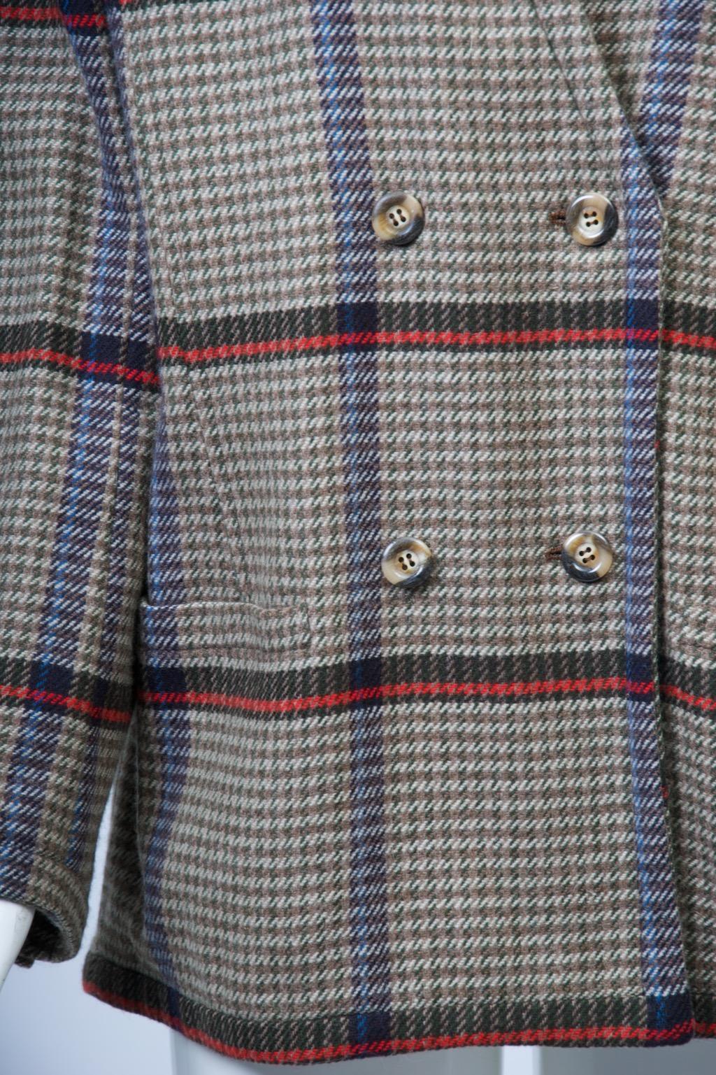 Valentino jacket in soft wool plaid, the small check ground primarily in tan, ivory and olive green punctuated by horizontal bands in brown and red and thin vertical bands in brown and blue. The jacket features a double-breasted straight cut with a