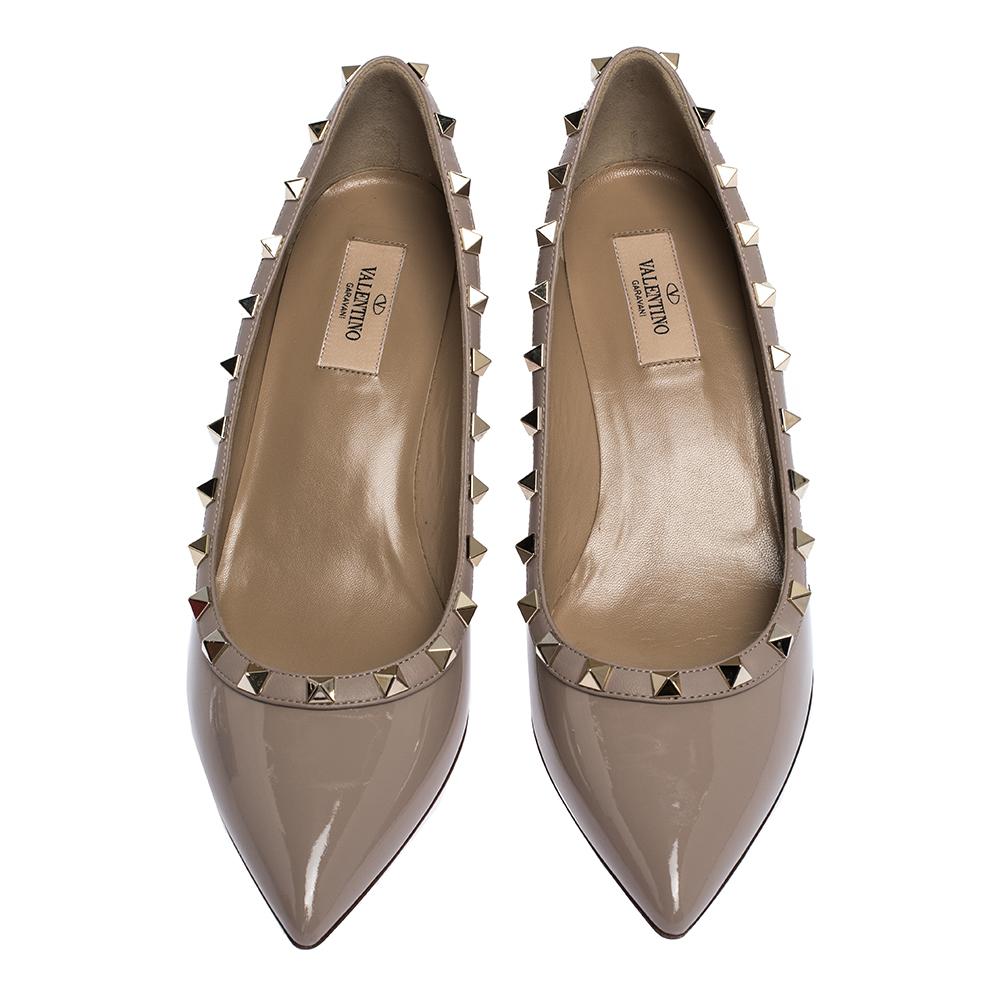 Lend a contemporary touch to your look when you team your outfit with this pair of Valentino pumps. They are crafted from patent leather and designed with pointed toes, wedge heels, and Rockstud details. You will enjoy parading this pair.

Includes: