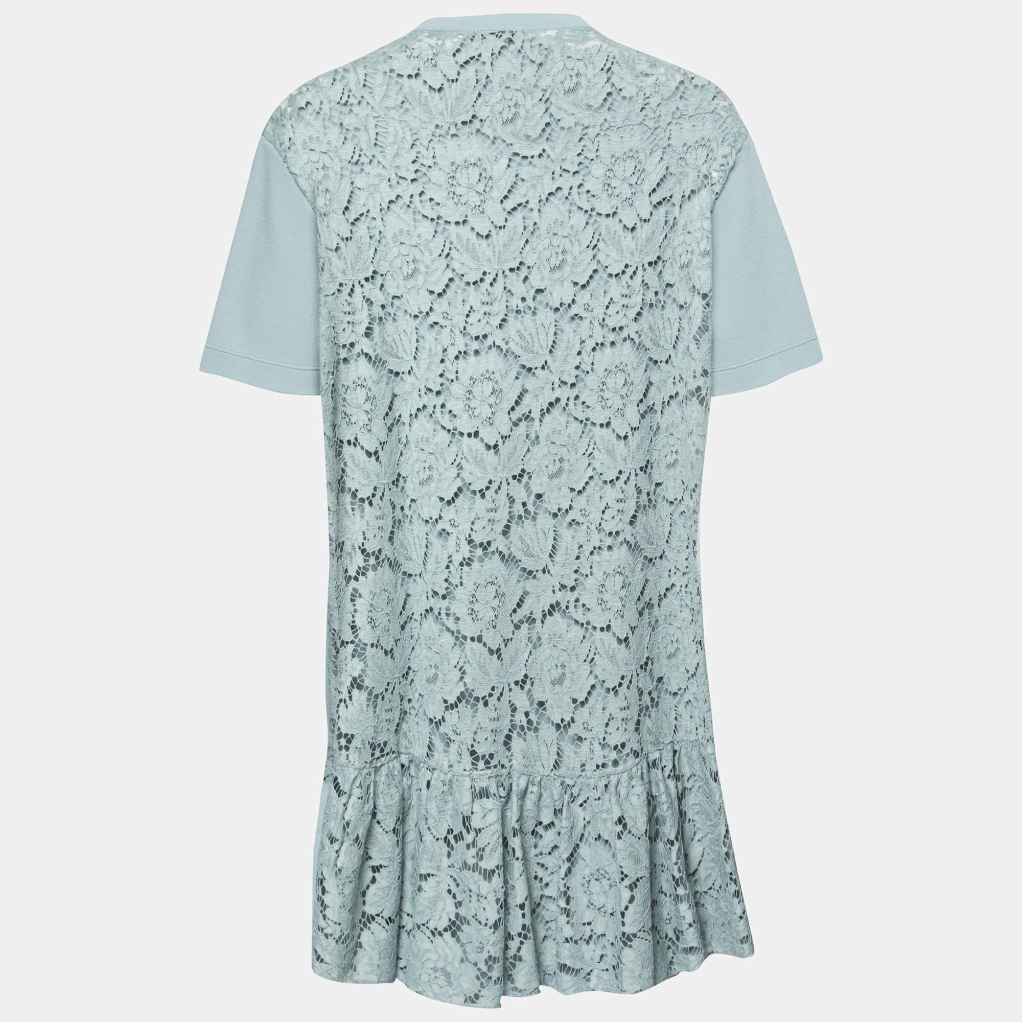 This Valentino dress is distinguished by two different designs on its back and front. Made from a mix of quality fabrics, its backside is intricately decorated with lace detailing and panels at the hem. Short sleeves and a round neckline complete
