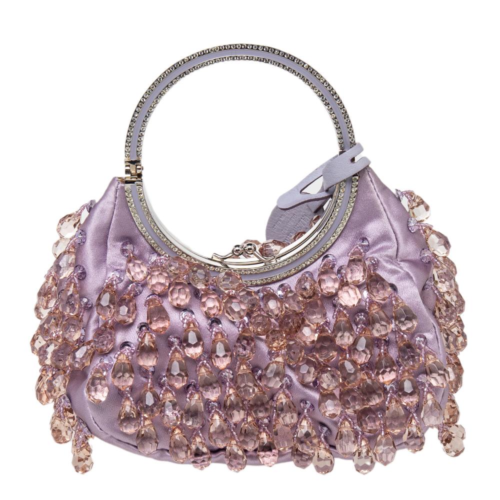 This stylish clutch by Valentino is perfect for evenings. Crafted from luxurious satin, this purple bag is adorned with crystal embellishments and also comes with a crystal-embellished sturdy handle. The satin interior is perfect for party