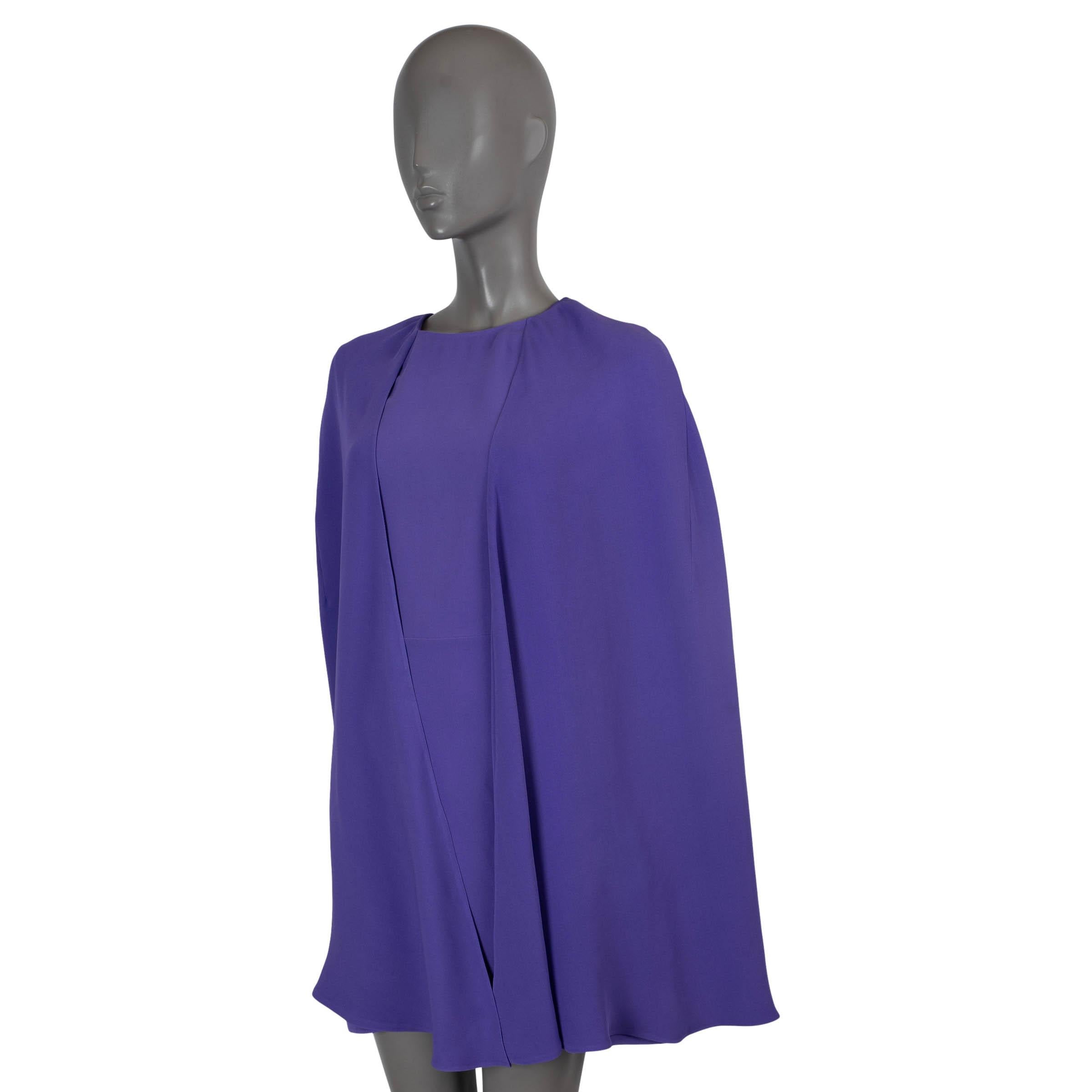 100% authentic Valentino mini cocktail dress in purple cady silk (100%). Features a crewneck, cape sleeves and two pockets at the waist. Opens with a keyhole button and concealed zipper in the back. Has been worn and shows slight wear on the inside