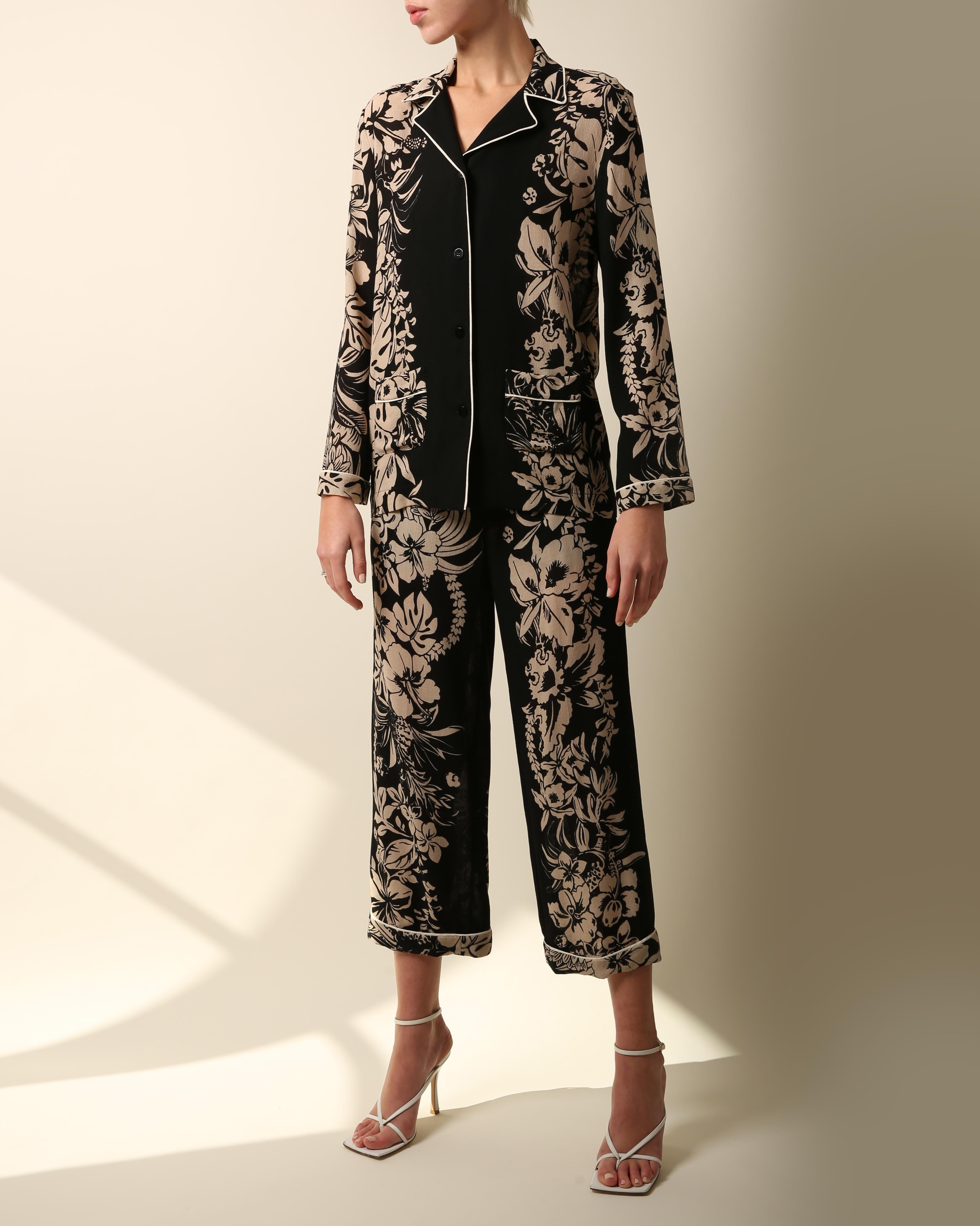 A beautiful two piece set by Valentino consisting of a button up blouse and wide leg turned up pants
Loose fitting pyjama style 
Black and nude floral print with white piping
Two pockets to the blouse that is cut for an oversized fit
Zip and hook