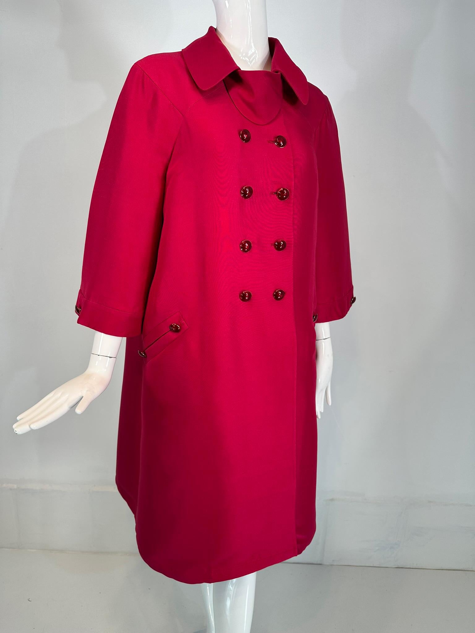 Valentino Raspberry Red double face silk, double breasted, inverted pleat back evening coat with a self belt. 
Double face silk is finished inside with taped seams. The coat has a romantic 50s silhouette when worn without the belt. It's more modern