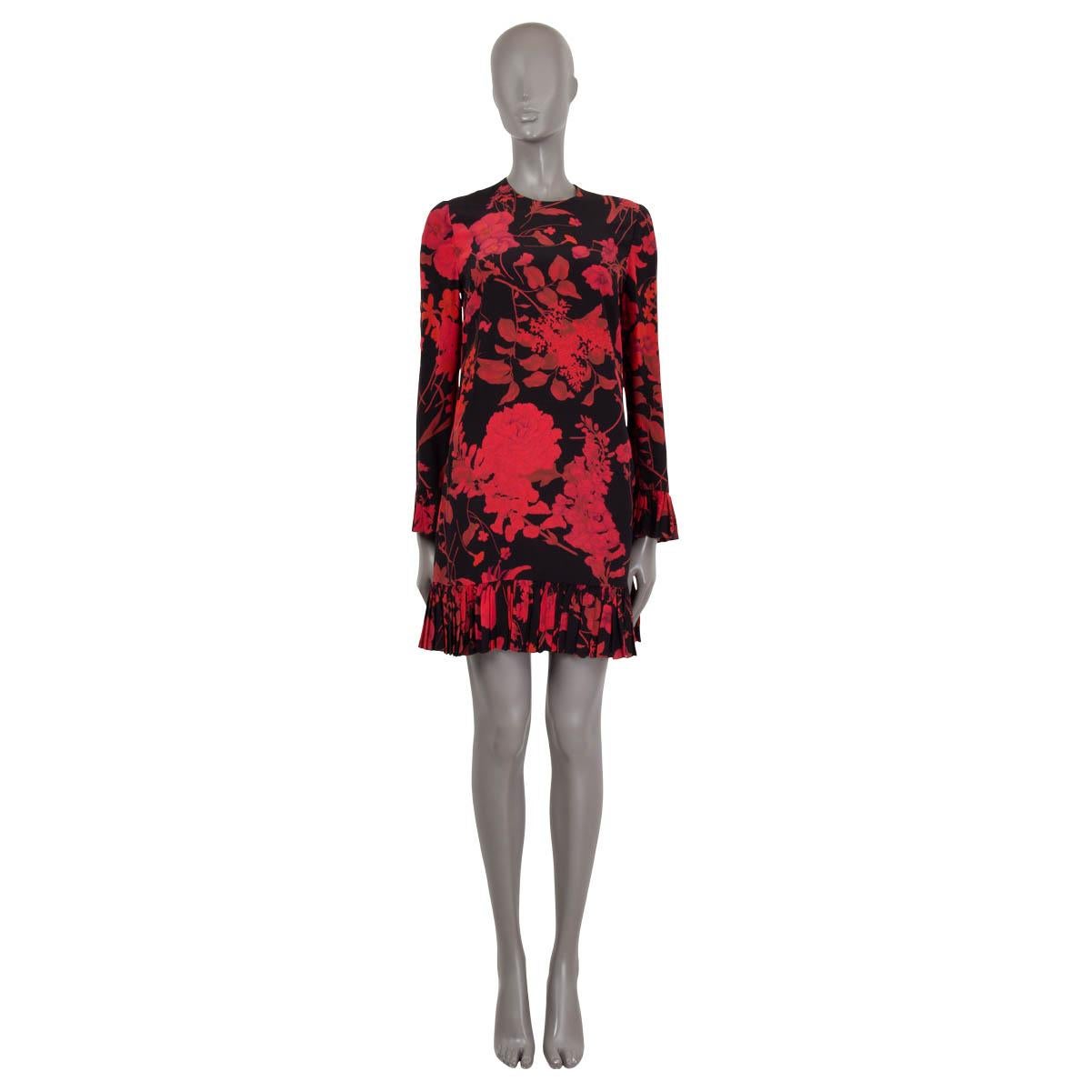 100% authentic Valentino 3/4 sleeve shift dress in red and black floral print silk crepe de chine (100%). Opens with a concealed zipper at the back. The design features a round neck, pleated hem and cuffs and comes with slit side pockets. Has been
