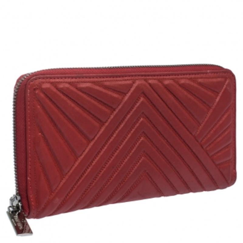 A compact and practical option to store your handy essentials, this Valentino wallet is crafted from red, coated fabric. It has a zip-around closure and is equipped with card slots and a zip pocket to keep things organised.
