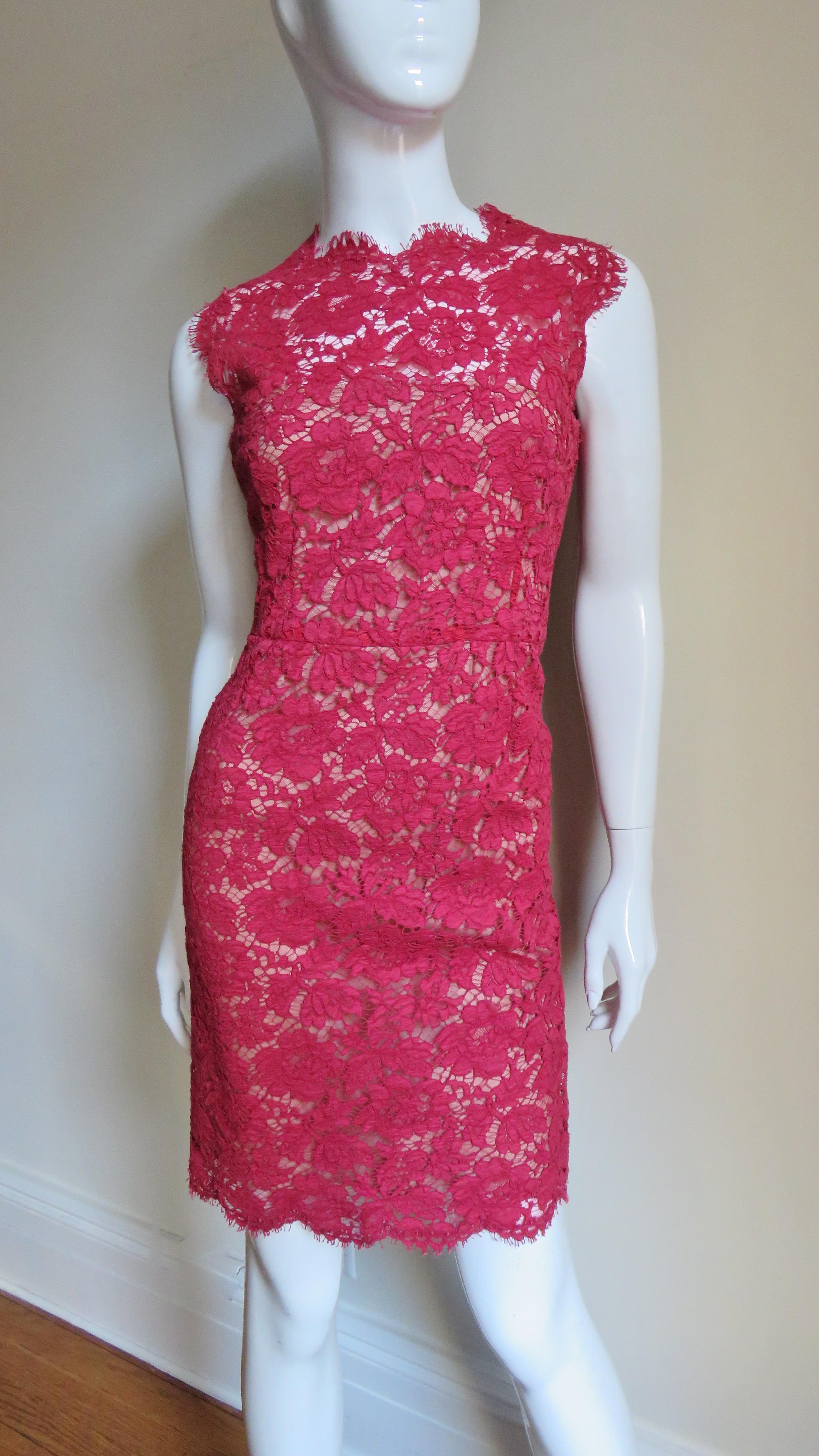 A beautiful red lace dress from Valentino.  It is a sheath with the crew neck, arms, center back and hem finished in the scallop edge of the flower and leaves pattern lace.  There is a waist line seam and the skirt is straight.  Under is flesh