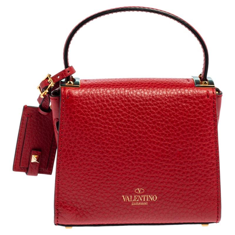 This mini My Rockstud bag from Valentino will lift up any outfit. Crafted from red leather, the bag has a single top handle, a leather tag, and gold-tone hardware. The flap closure opens to a leather lined interior that is sized to hold your