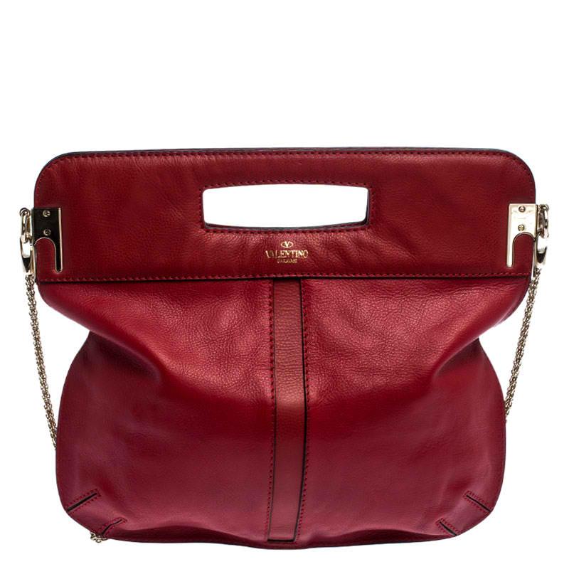 This hobo by Valentino has a fashionable look. Crafted from red leather, the bag comes with a spacious fabric interior and is held by inbuilt handles and a chain. It is finished with a gold-tone Rockstud trim along the center.

Includes: The Luxury