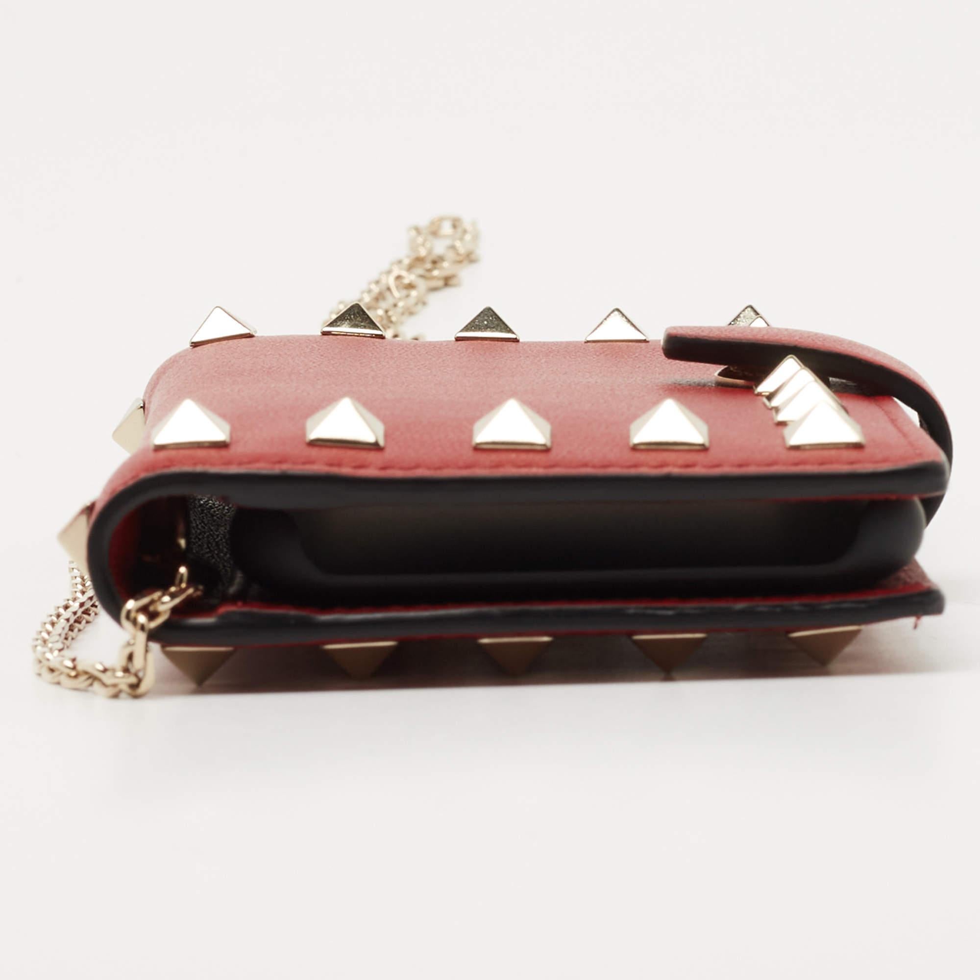 Valentino makes everyday essentials stylish just like this leather phone case. The signature studs on the exterior lend it a signature appeal. The accessory is perfect for carrying your phone and cards.

Includes: Original Dustbag, Original Box,