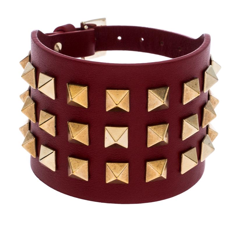 Define your delicate wrist by wearing this open cuff bracelet from Valentino. This leather comes fashioned with the signature Rockstud details and buckle closure. This lovely piece can be accessorized with a casual outfit.

Includes: Original