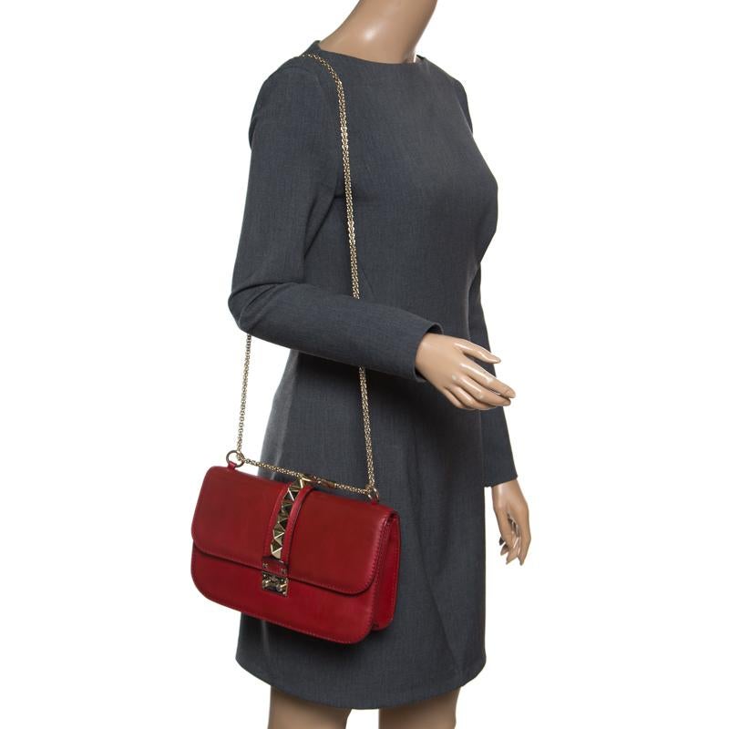 If you're looking for a bag with a blend of modern style and class, this Valentino shoulder bag is the answer. Crafted from leather in Italy, this red piece comes with a gold-tone chain link and a flap with a push-lock to secure the fabric interior.