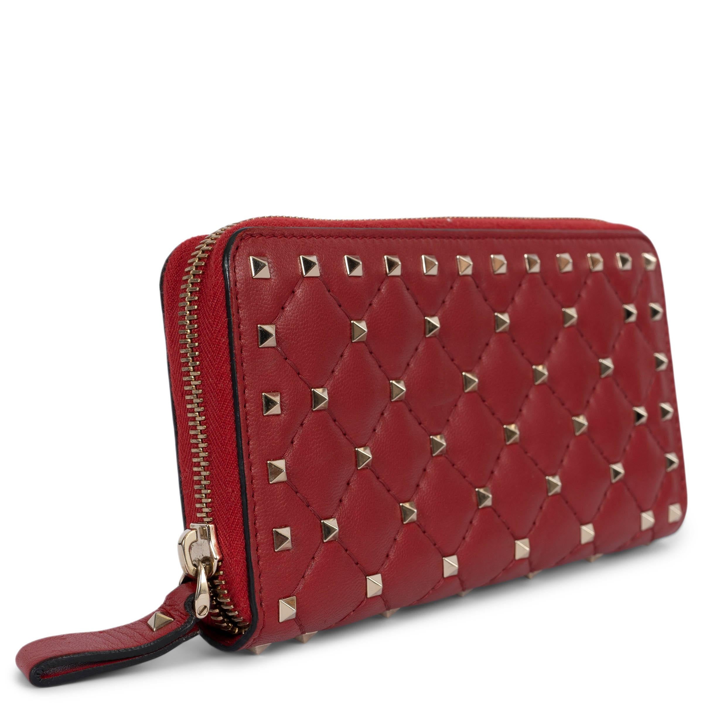 100% authentic Valentino Rockstud Spike continental zip wallet in red Nappa leather featuring light gold-tone hardware. Lined in red leather with twelve credit card slots, one middle zipper pocket and several bill compartments. Brand new. Comes with