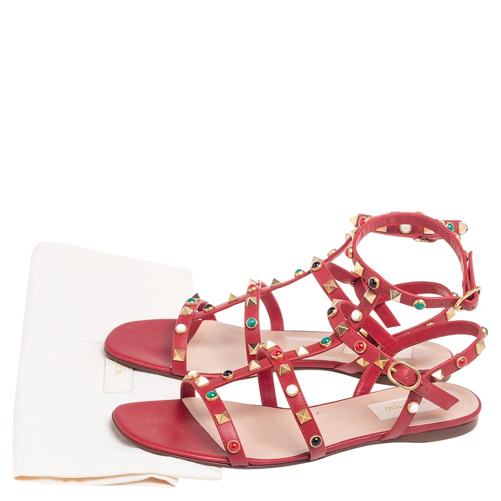 These Valentino thong flat sandals are made for leather in red. They're decorated with Rolling Rockstud accents, secured with buckles, and set on durable leather soles.

Includes: Original Dustbag