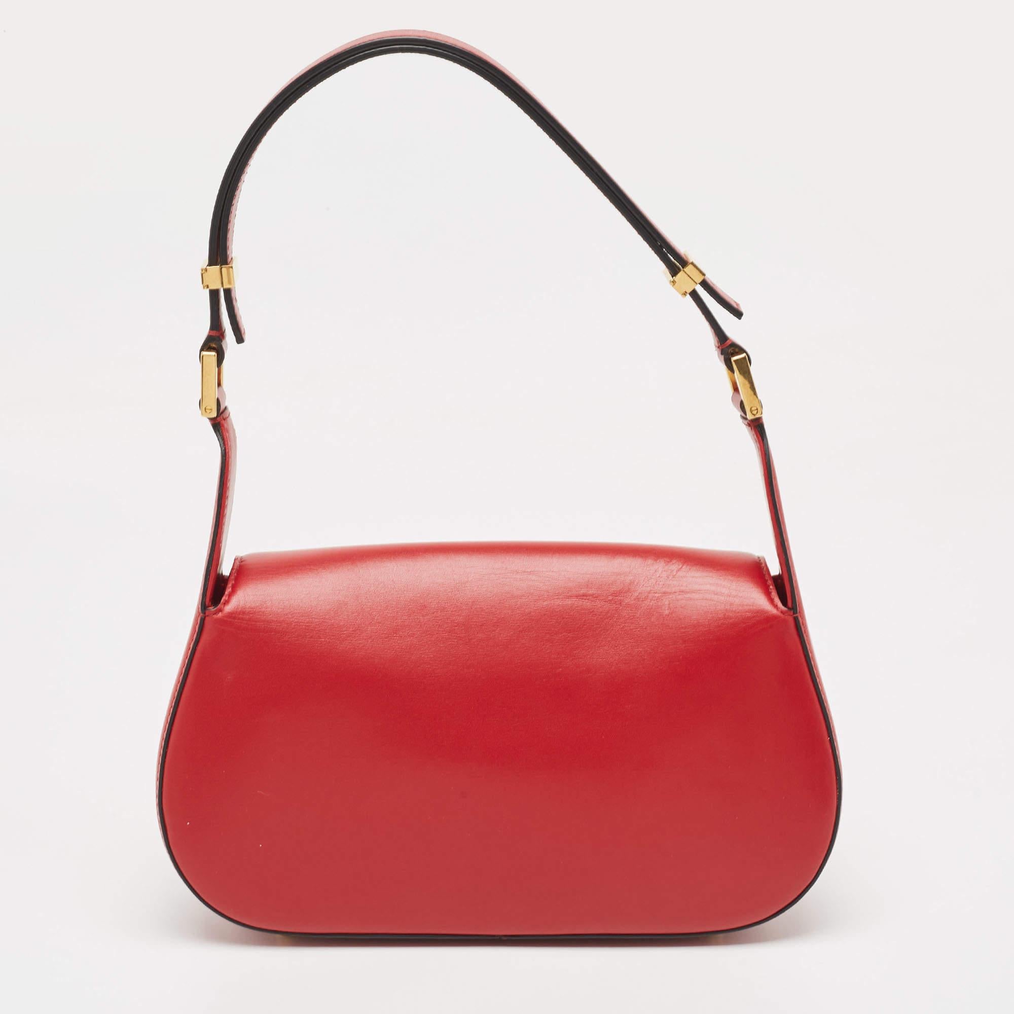 The Valentino bag exudes timeless elegance with its vibrant red hue and luxurious leather construction. Adorned with the iconic VLogo hardware, it boasts a chic chain strap for versatile styling. This sophisticated accessory effortlessly elevates