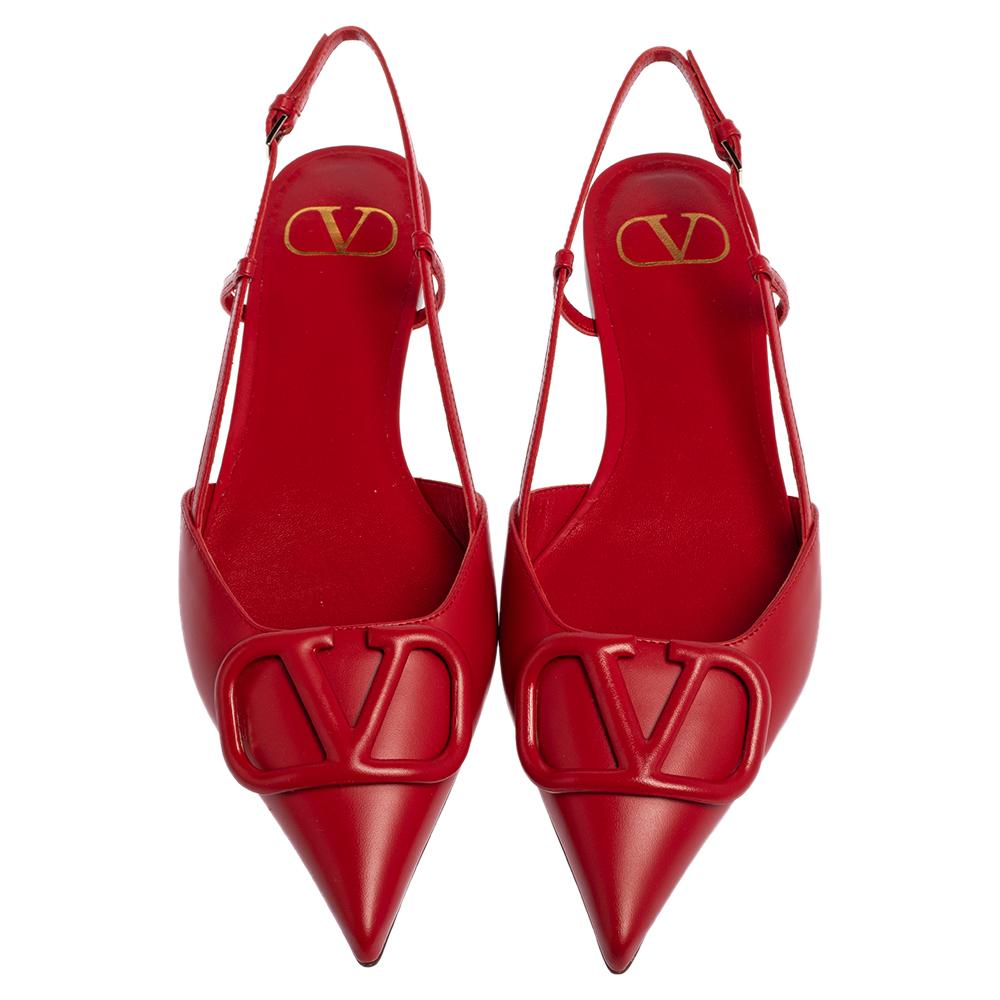 These stunning sandals showcase Valentino's feminine sensibilities and elegant aesthetics. Crafted from leather in a red shade, the pointed-toe silhouette is graced with the VLogo Signature motif on the uppers. Secured with slender slingbacks, the