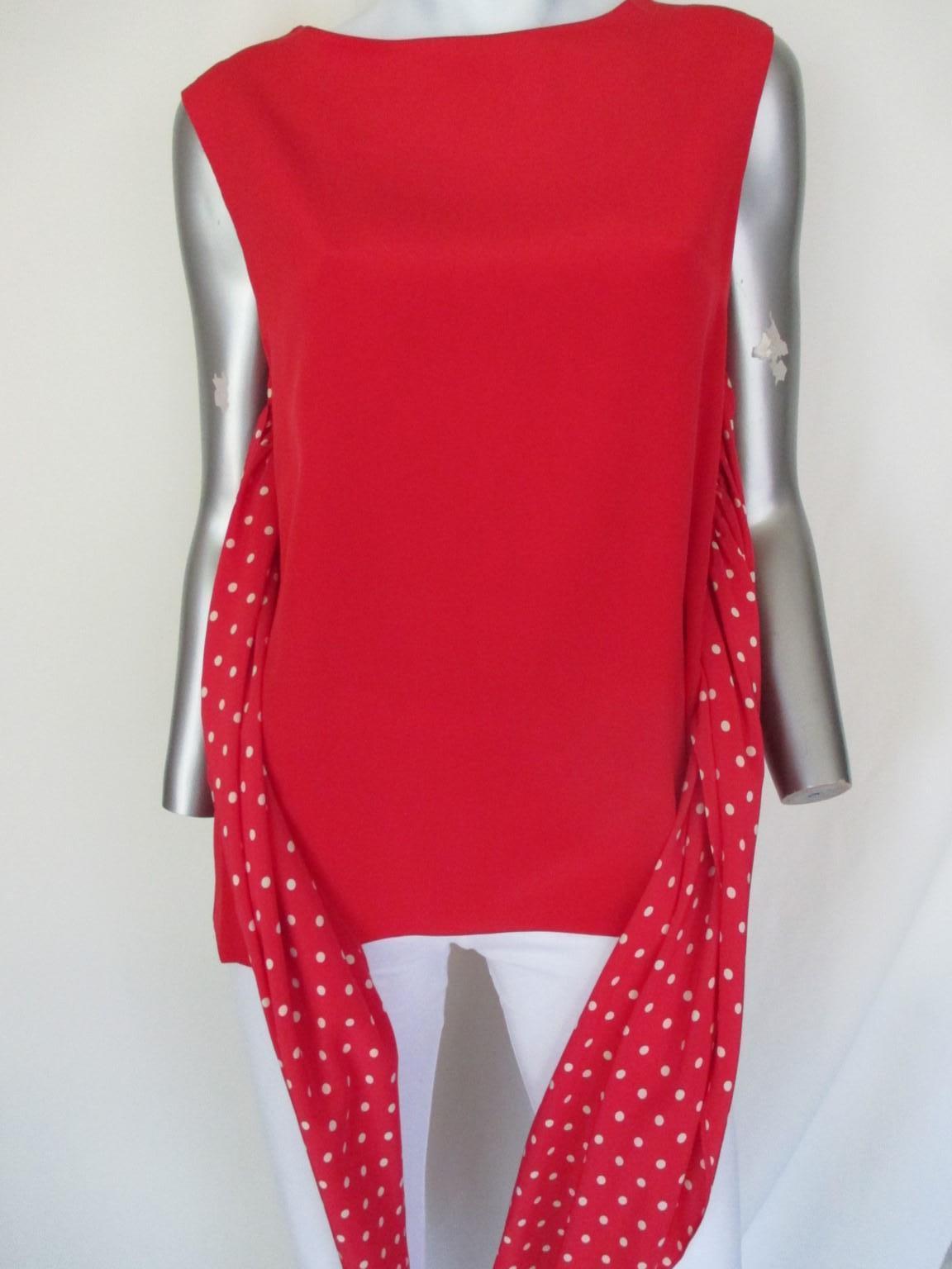 Vintage red silk Valentino from the miss V collection with white polkadots.
We offer more exclusive vintage items, view our frontstore.

The blouse has two attached parts on each side for closing in front and back with a long side zipper.
Appears to