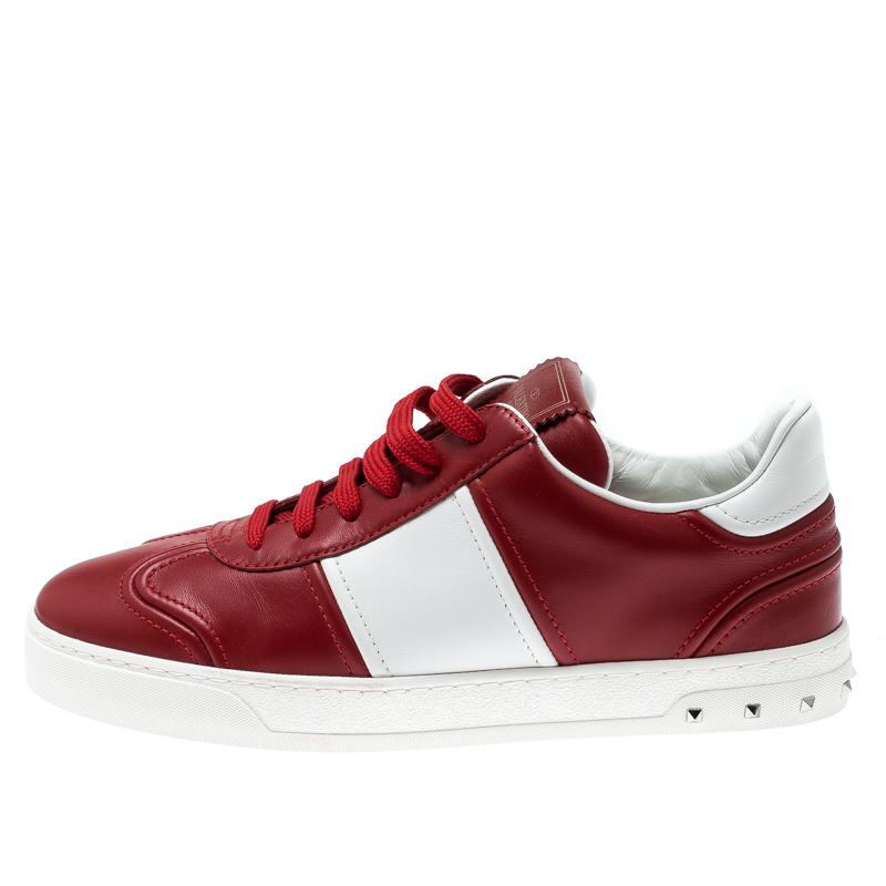 Ace the sneaker game in these fabulous ones from Valentino! These Fly Crew sneakers are crafted from red and white leather and feature round toes and lace-ups on the vamps. They flaunt the signature Rockstud detailing at the heels and come equipped